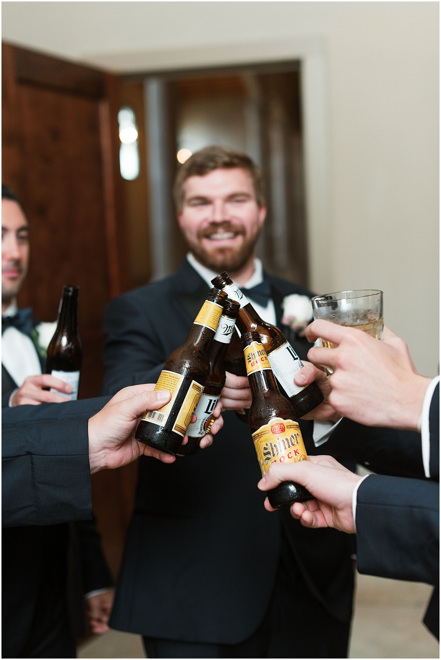  groom and groomsmen drinking beer before the wedding 
