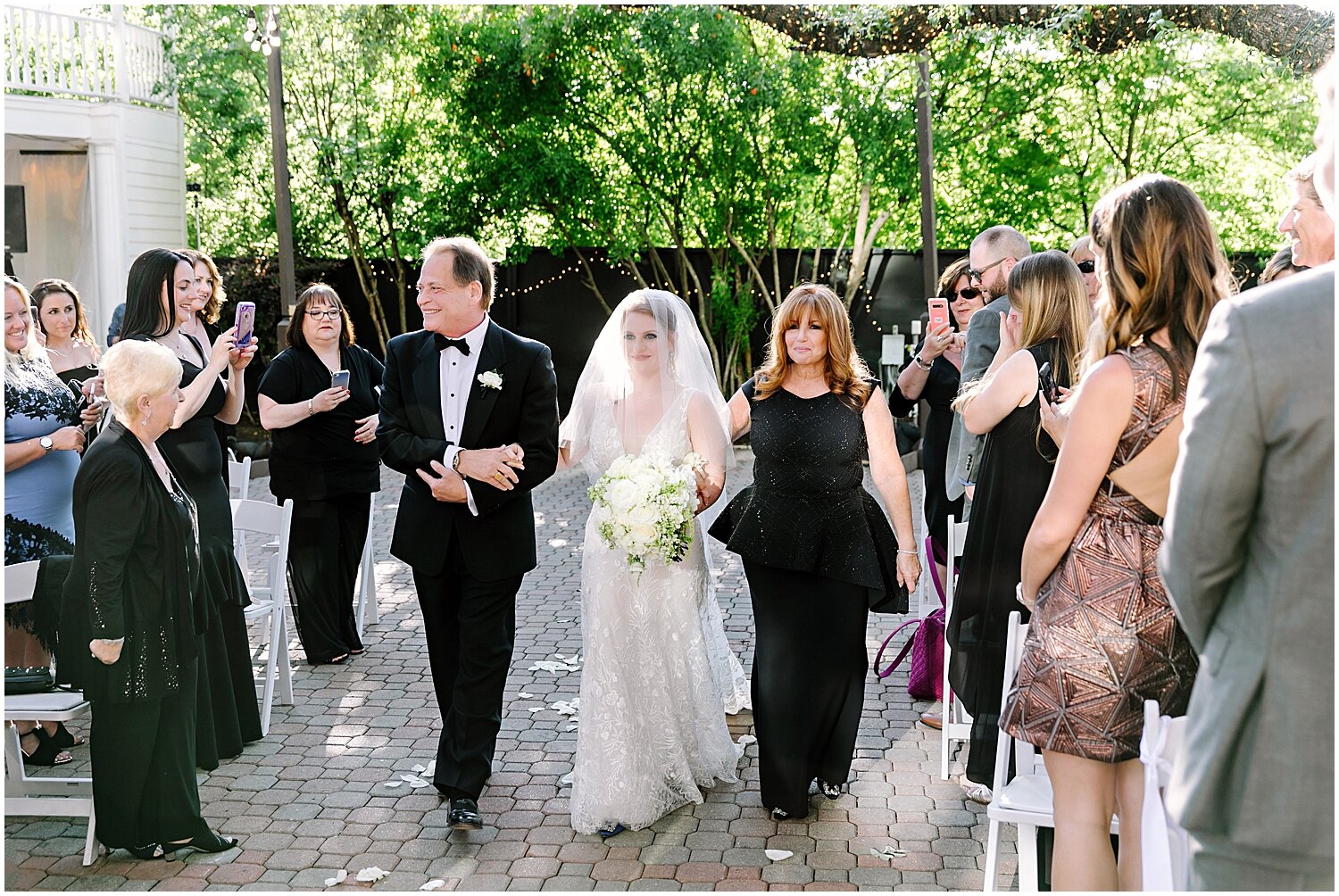  bride walking down the aisle with her parents 