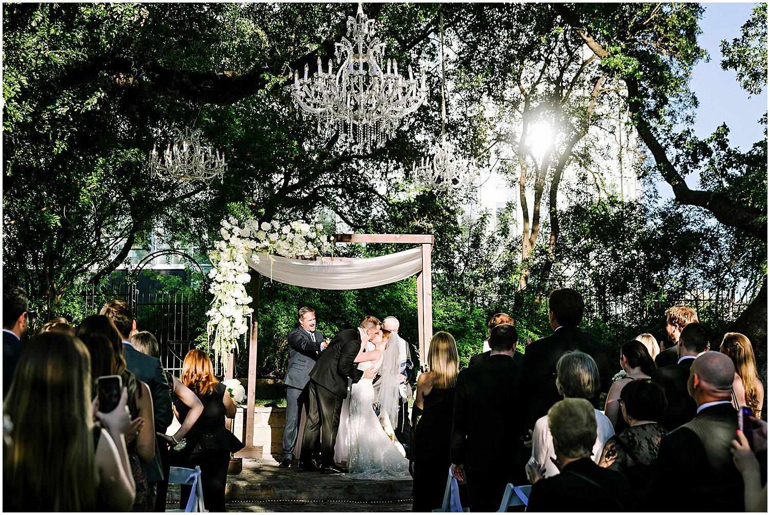  bride and groom kiss at their wedding ceremony 