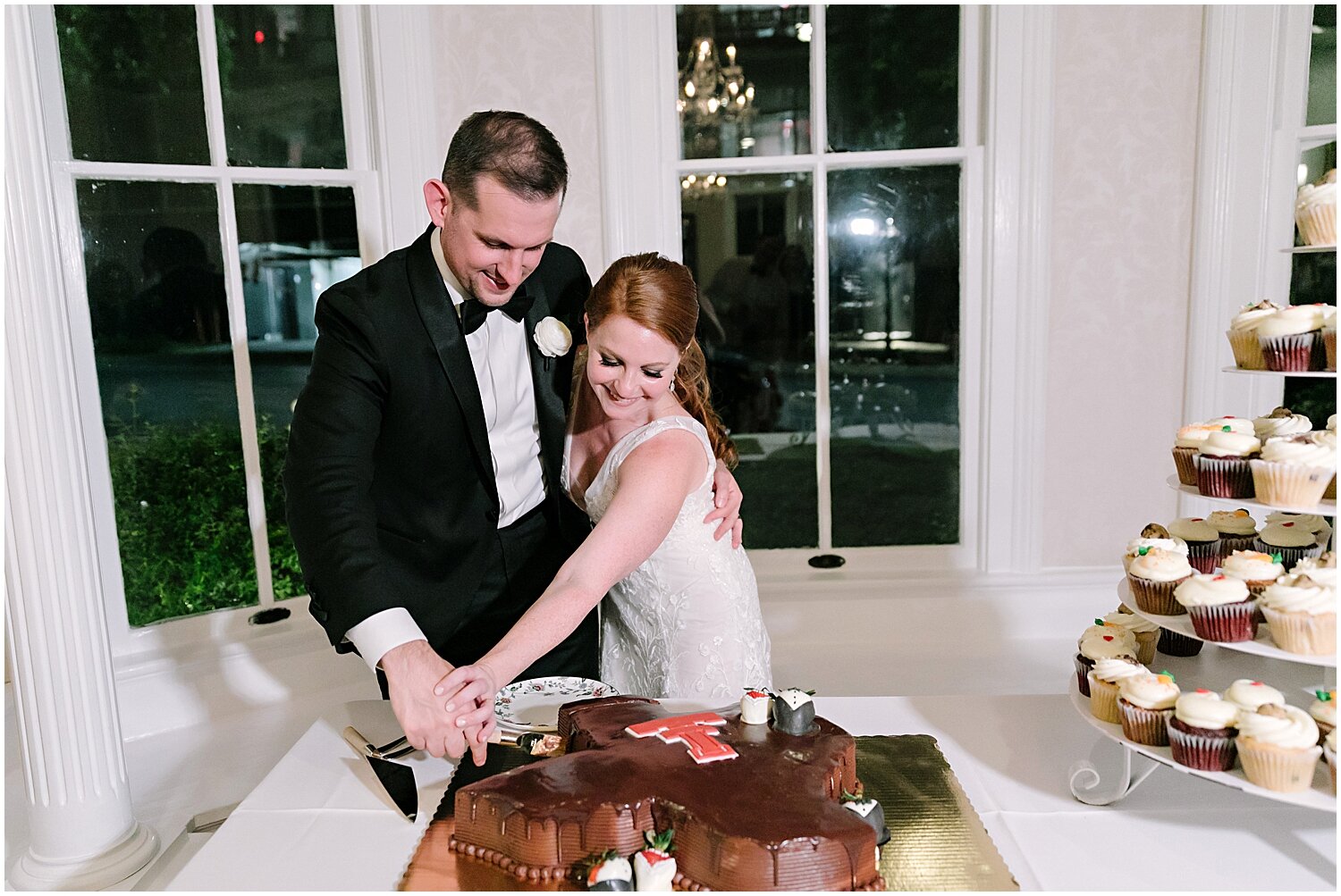  bride and groom cutting their wedding cake 