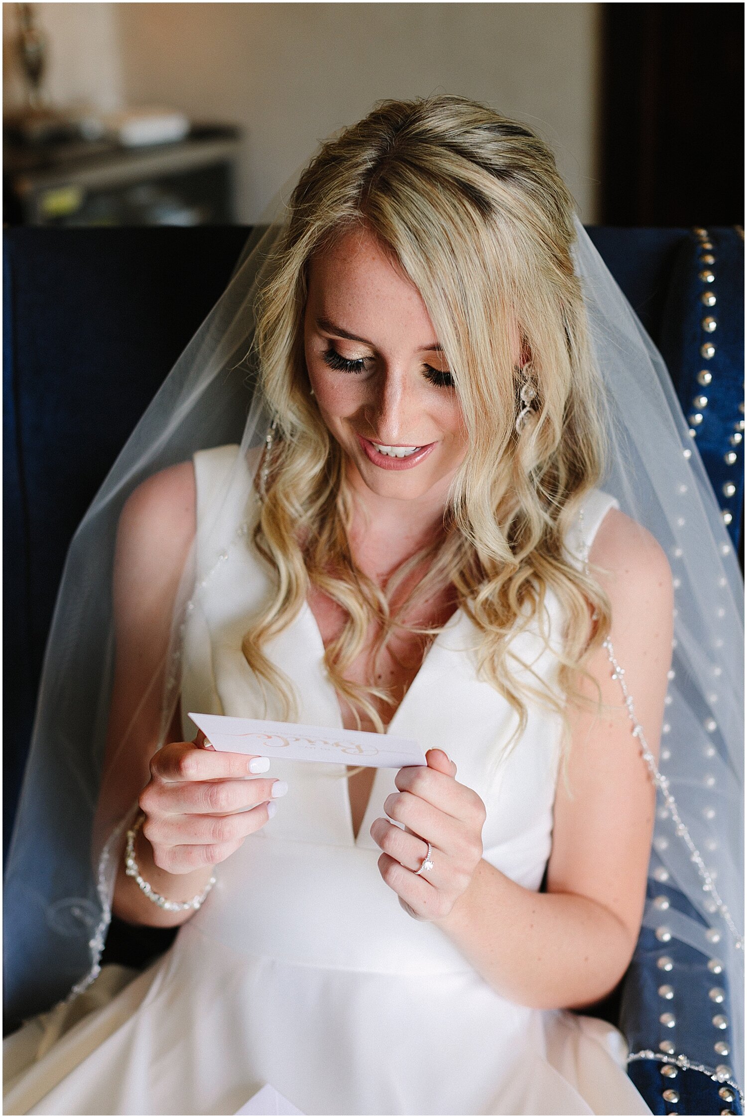  bride getting emotional reading a letter before the wedding 