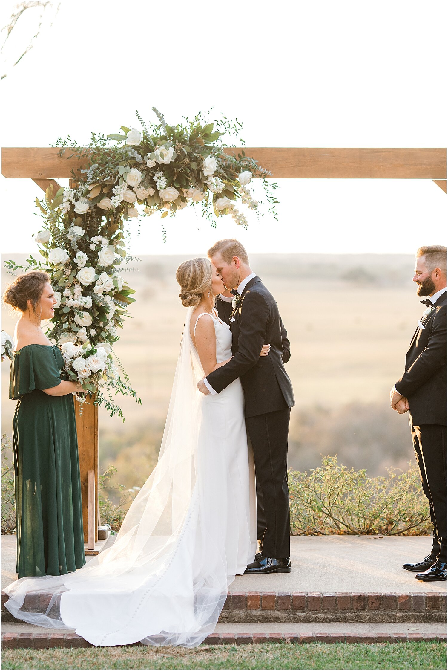  bride and groom kiss during their wedding ceremony 