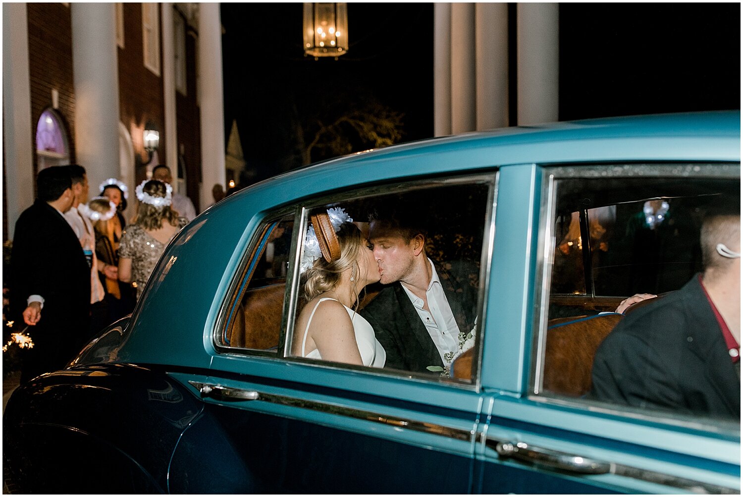  bride and groom in their getaway car 