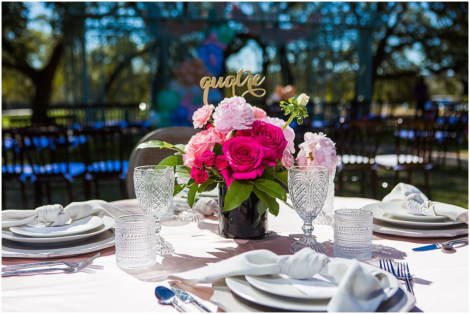  pink floral centerpiece and french table number signs 