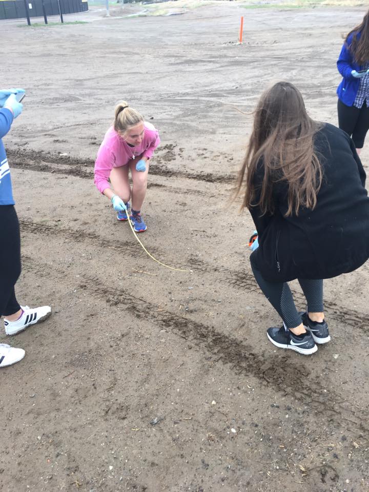 Students measuring ground outside