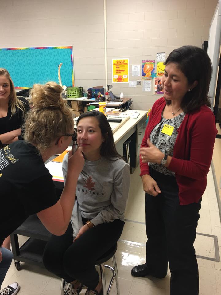 Medical students learn how to properly perform eye exams.