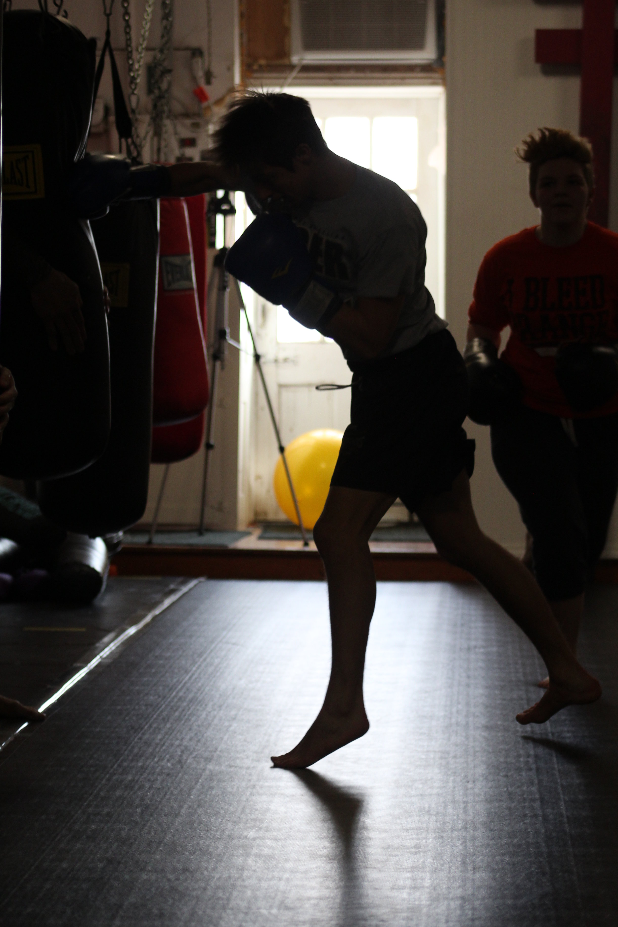 Student punching a punching bag.