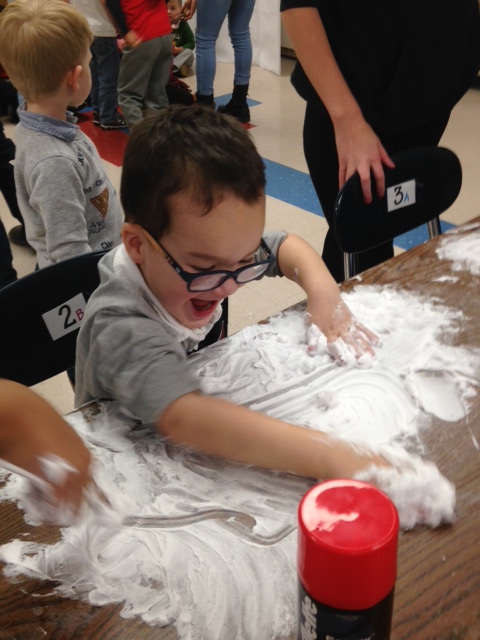 Elementary school student has fun playing with flour.