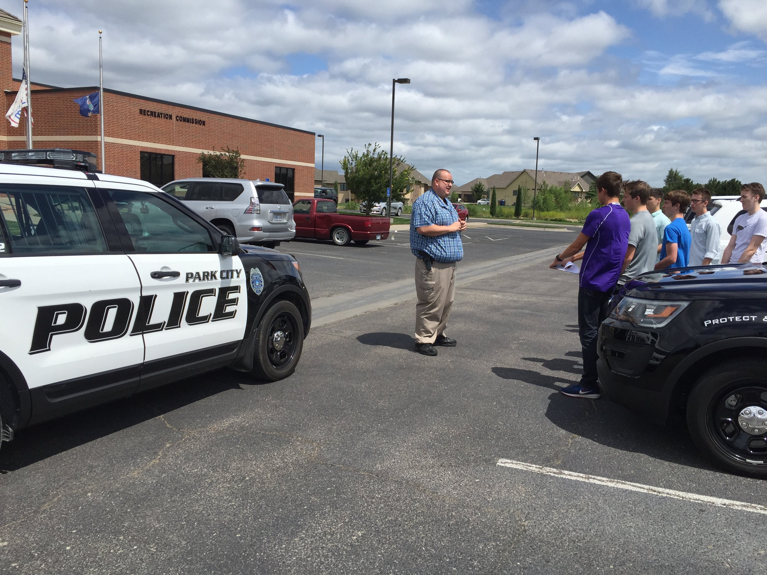 Park City Law Enforcement officer explains police car technology to students