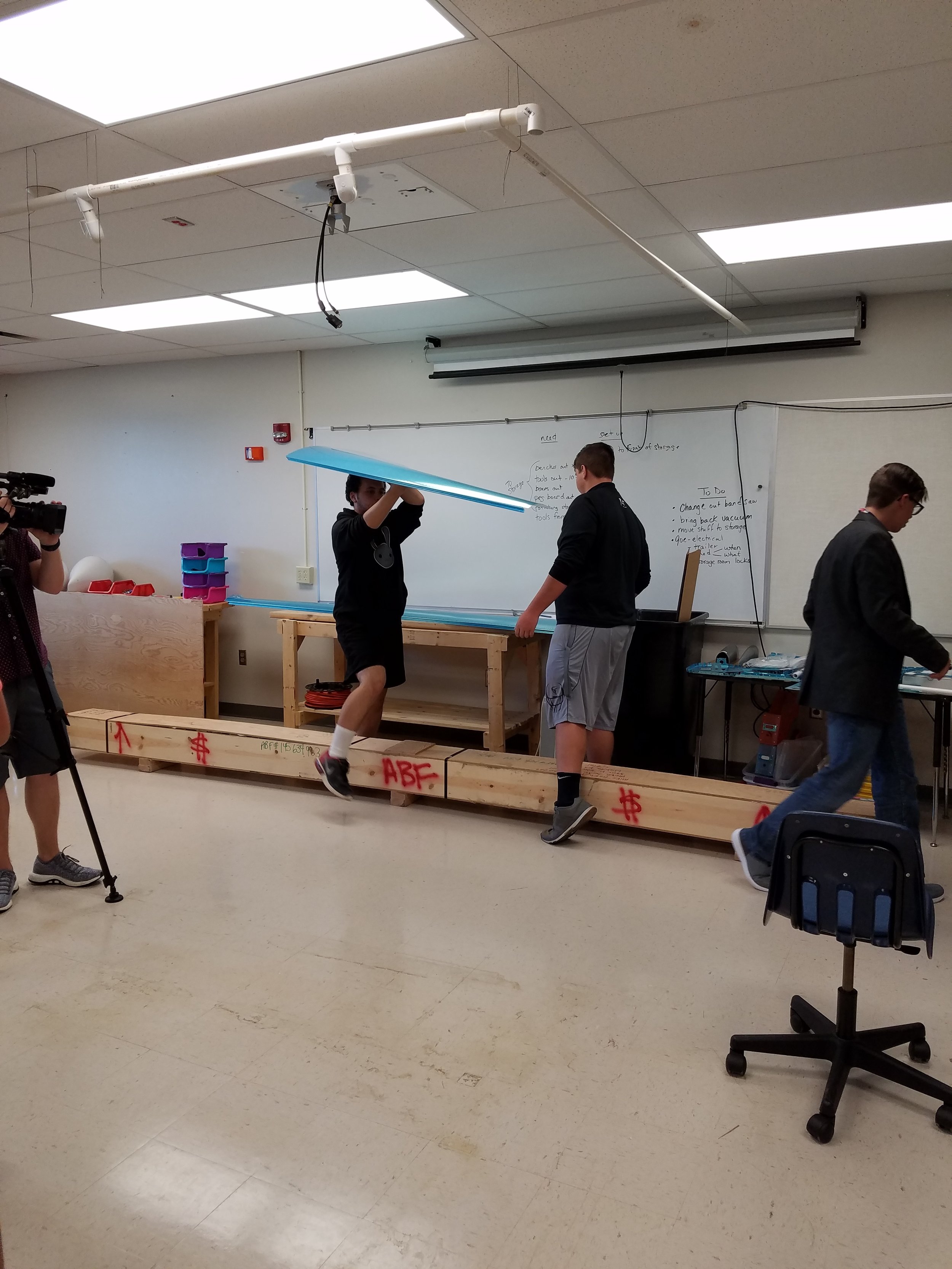 Engineering students carries part of his project.