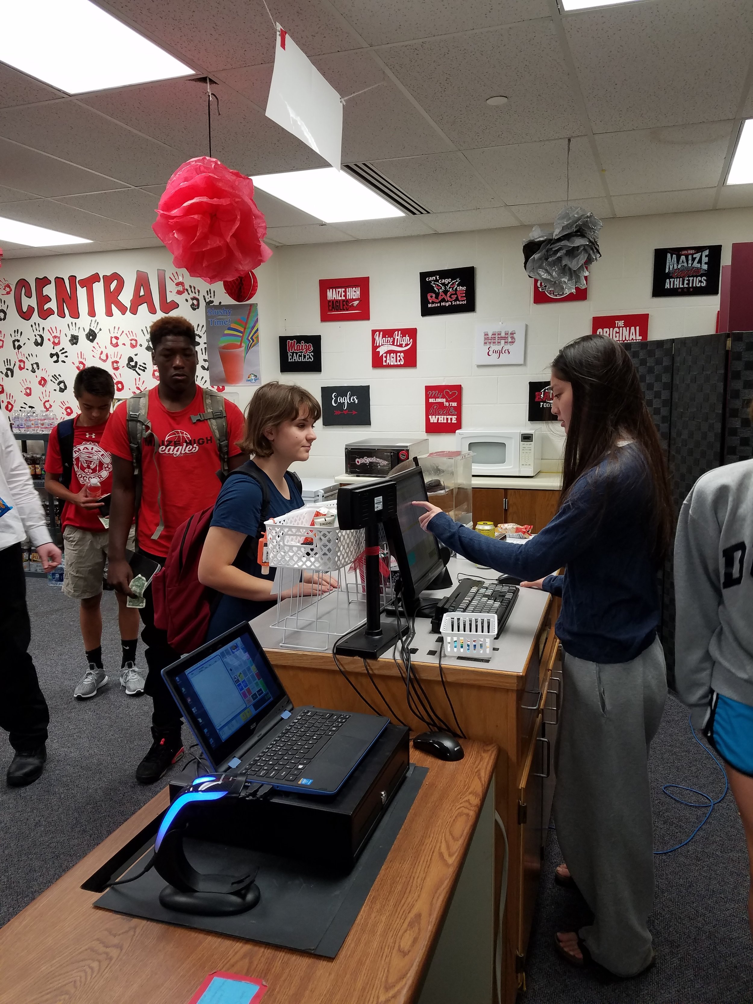 Maize students on both sides of the student-run store.