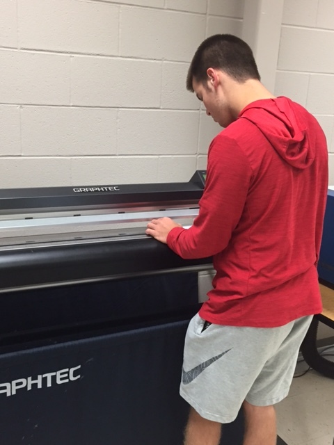 Graphic Design student works on his vinyl project.