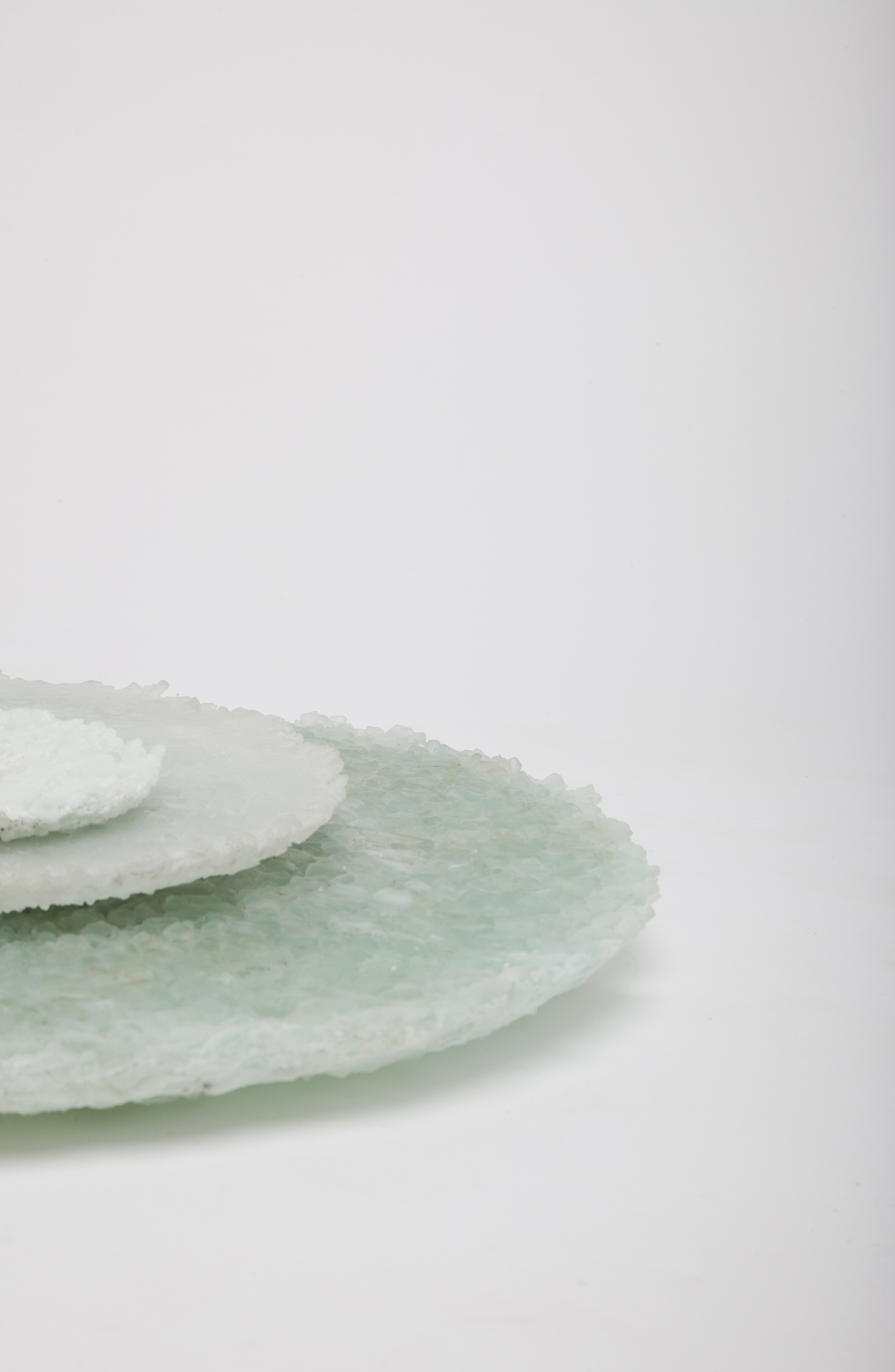 Perito Moreno Platters : The Perito Moreno platters are made out of reclaimed glass material. Glass production offcuts are sourced from a local glass manufacturer in London. These are broken down and fused together in a kiln at different temperatures allowing the material to merge and to create various textures and shades. The platters are named after the Perito Moreno glaciers in Argentina.