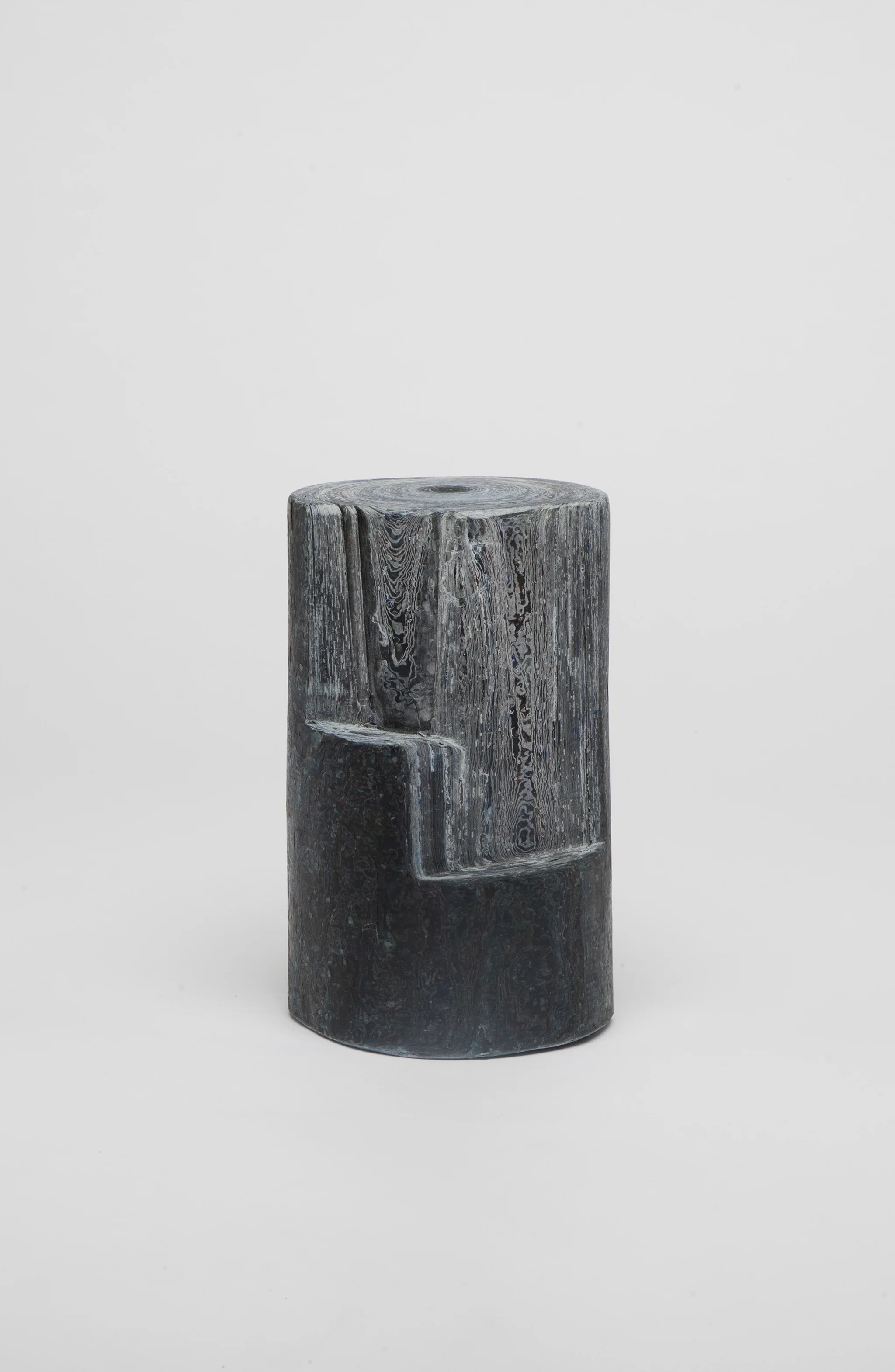 Silverwood Door Weigh t: The Silverwood Door weight is a unique piece made out of compressed layers of reclaimed local newspapers. The formation of tree-rings is replicated by adding material in layers and creating a tubular form. Leaving some areas trunk-like and carving others, displays the surface contrast. Paper, commonly perceived as a light-weight material becomes the weight of a space. Due to its blue-greyish colours it is named after the silverwood tree.