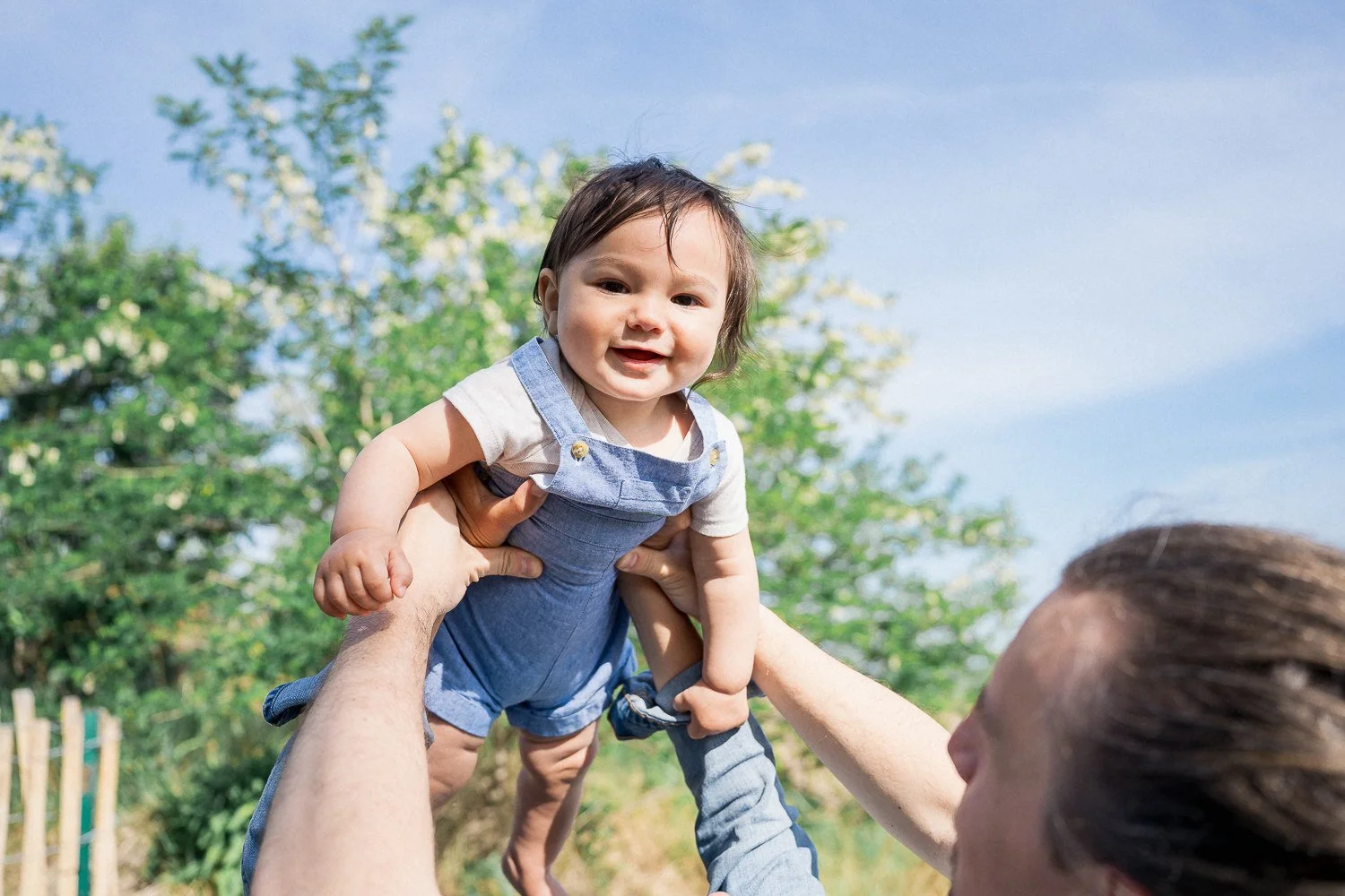 20-teresa-mansbach-baby-held-overhead-beneath-a-blue-sky-id-202.jpg