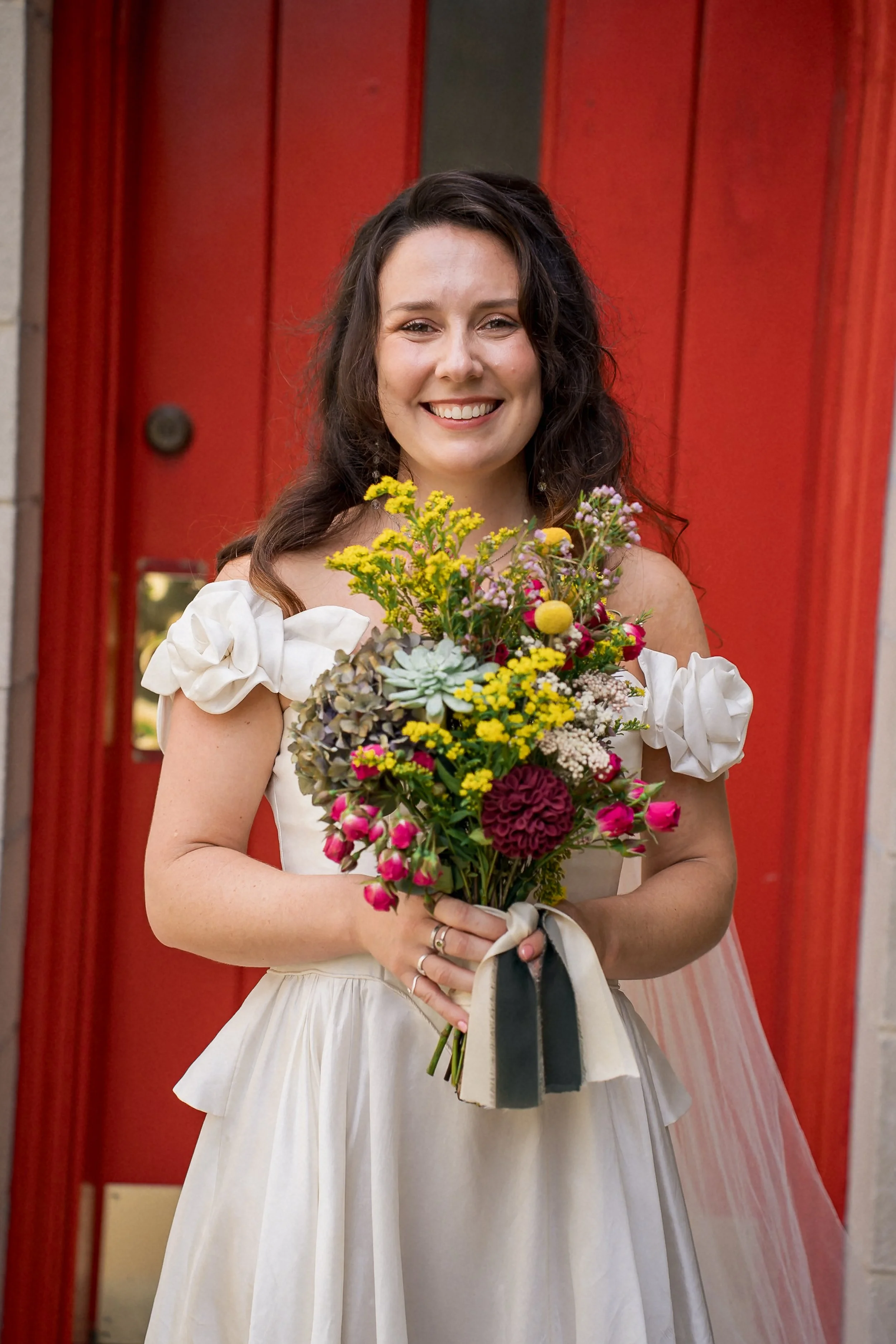 04-bride-colorful-bouquet-red-church-doors.jpg