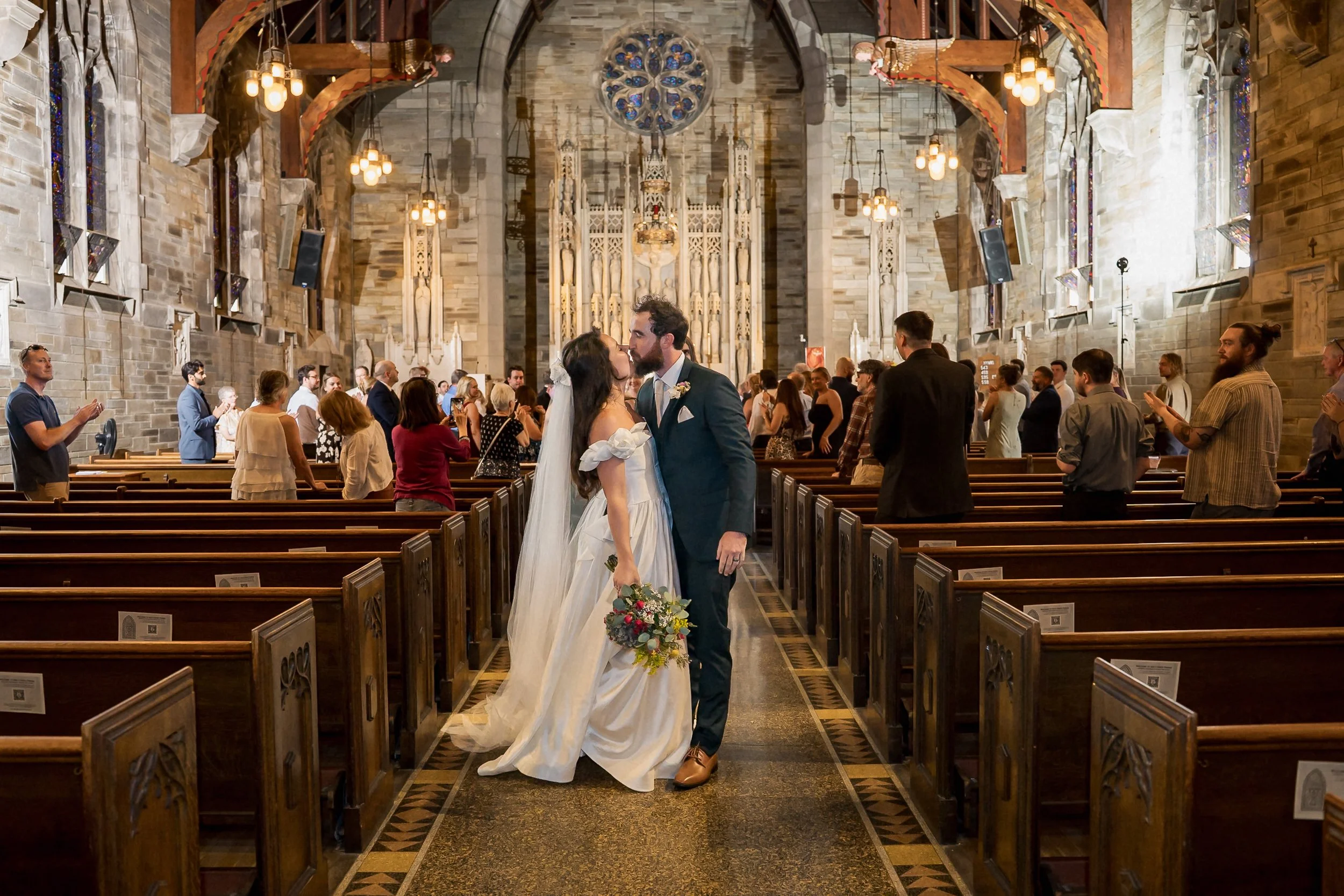 35-newlyweds-kiss-inside-holy-cross-church.jpg