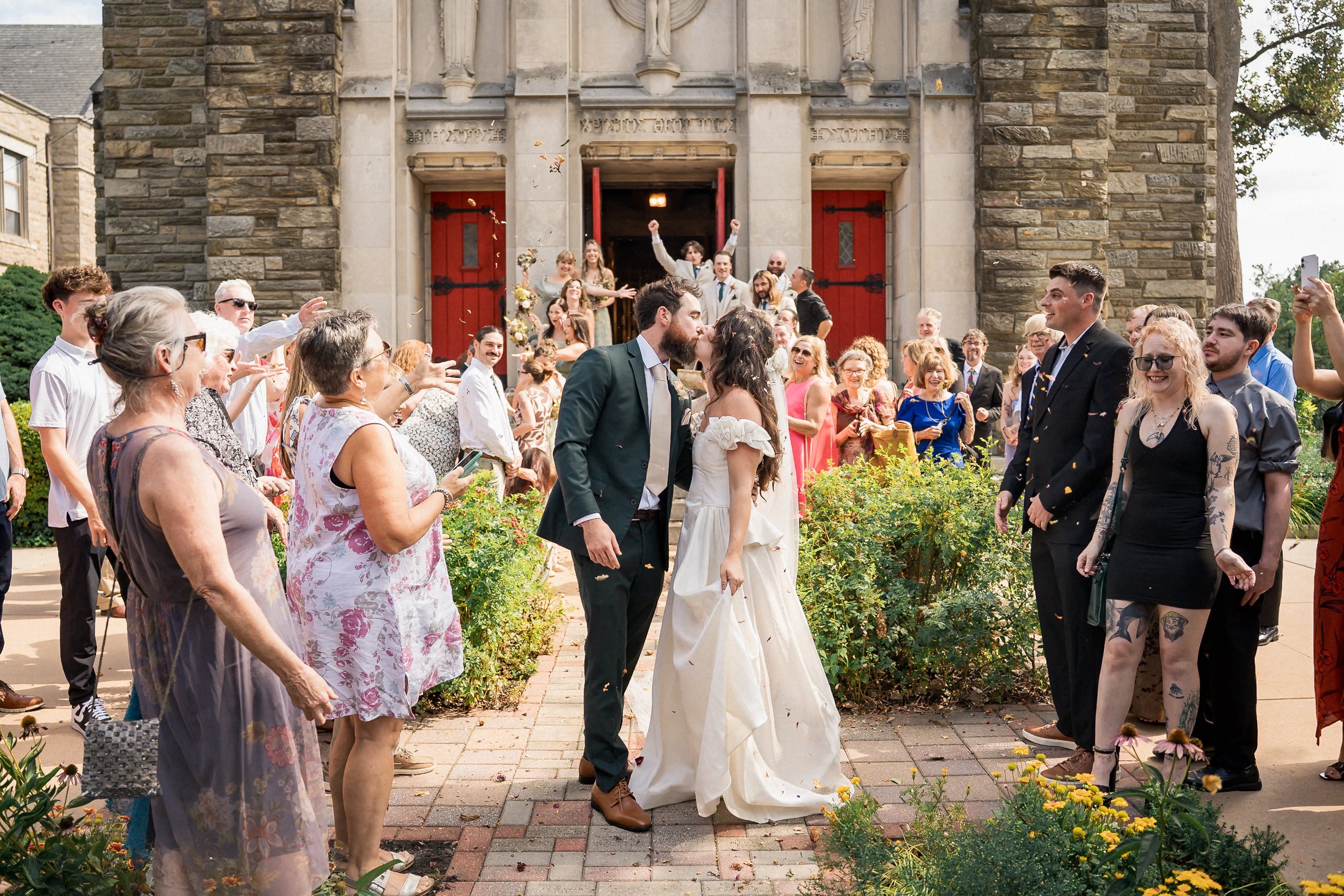 39-newlyweds-kiss-outside-holy-cross-church.jpg