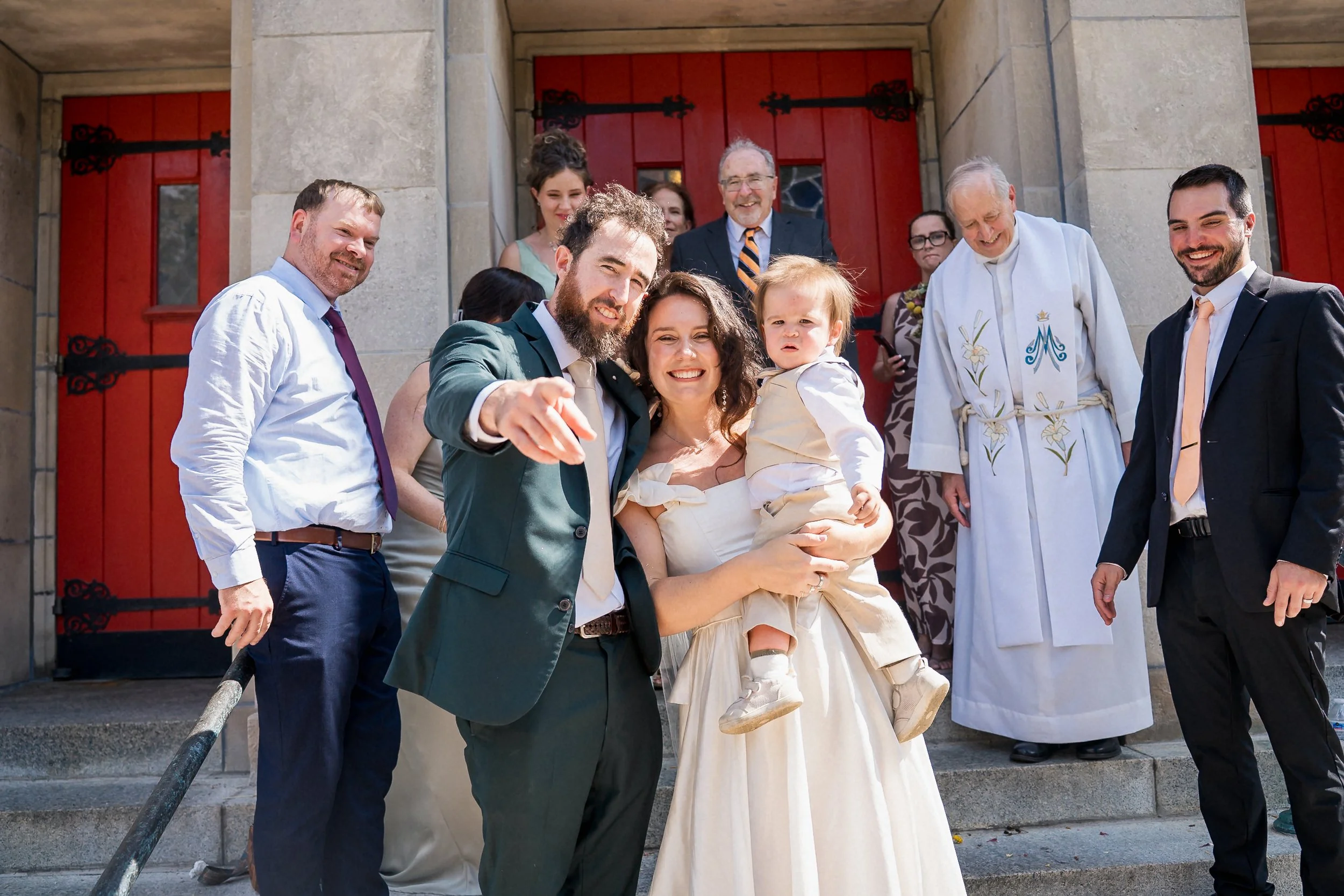 42-newlyweds-with-young-nephew-red-church-doors.jpg