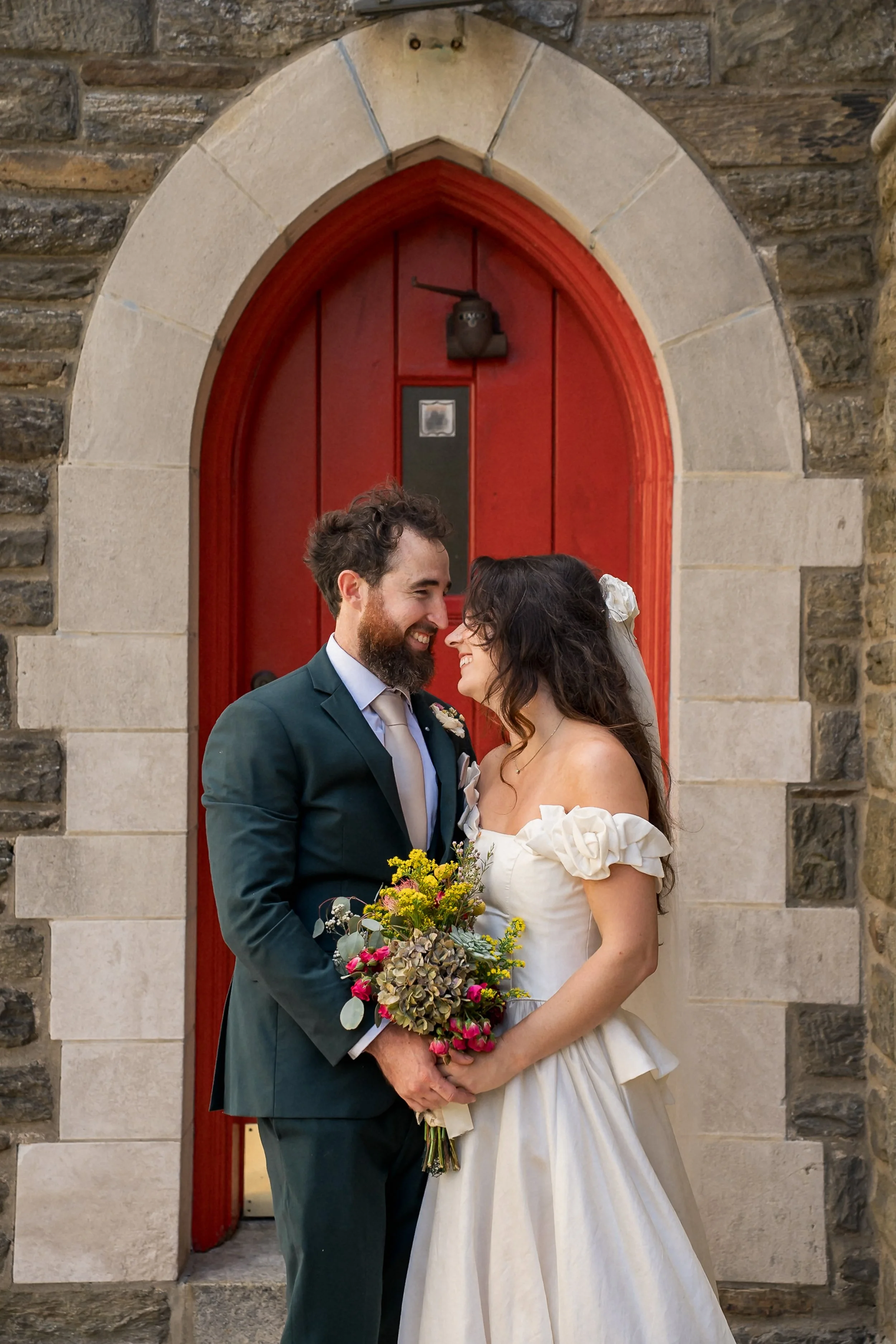 48-candid-newlywed-portrait-red-church-door.jpg