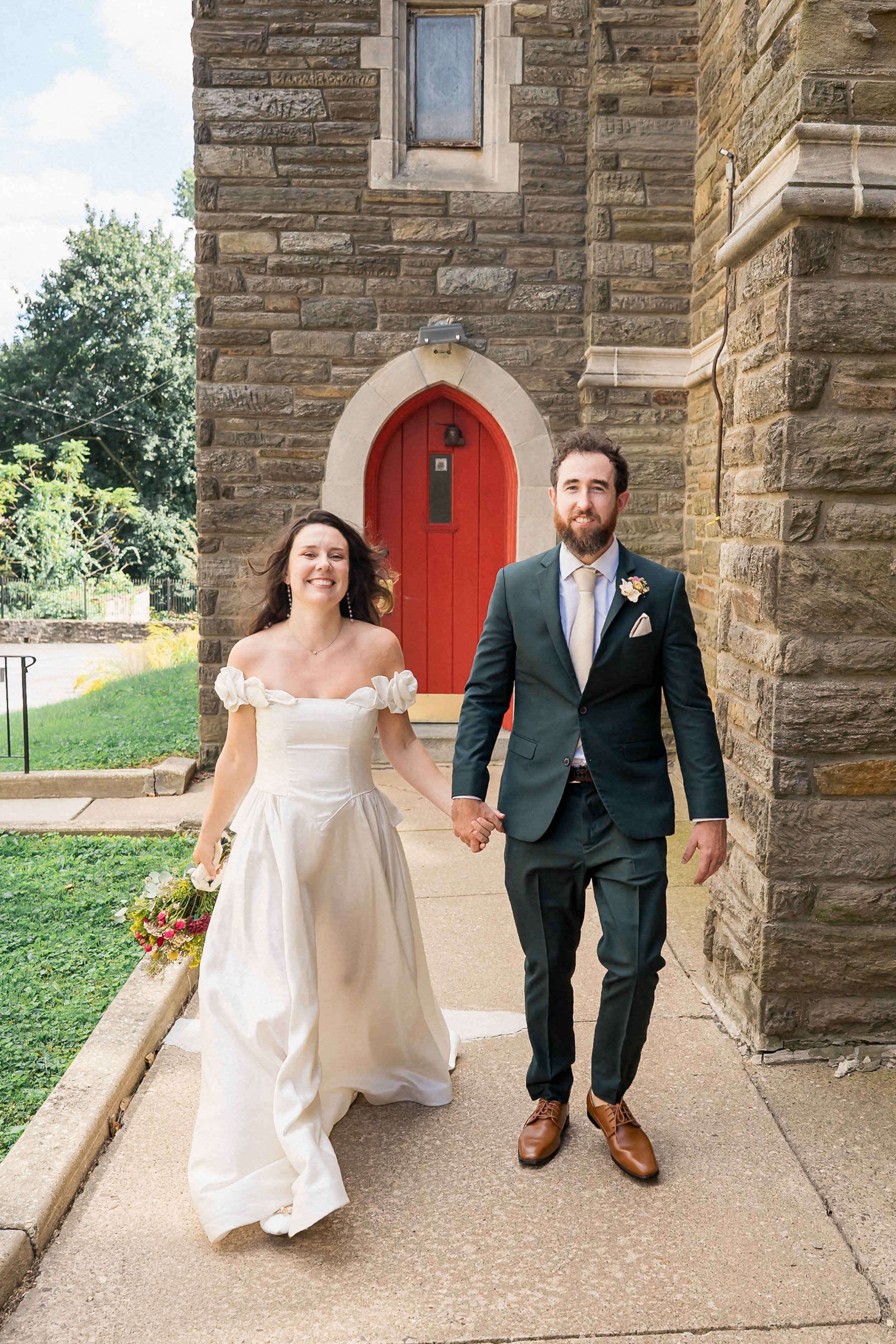 52-newlyweds-walking-holy-cross-church.jpg