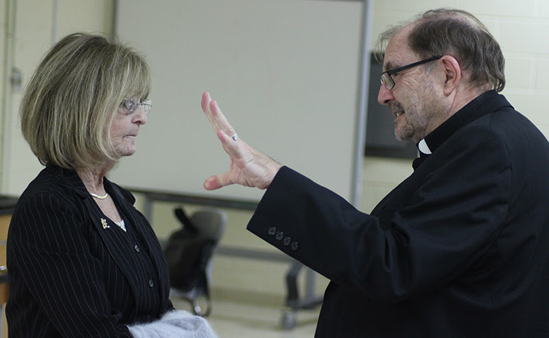 Helen Konstance, a cantor at St. Martha Parish in Philadelphia, speaks with Franciscan Father Frank Berna after his Oct. 14 lecture entitled “If Liturgy Were Like an Eagles Game.” Sponsored by the Association of Church Musicians in Philadelphia, the presentation surveyed strategies for increasing engagement at Sunday Mass. (Photo by Gina Christian.)