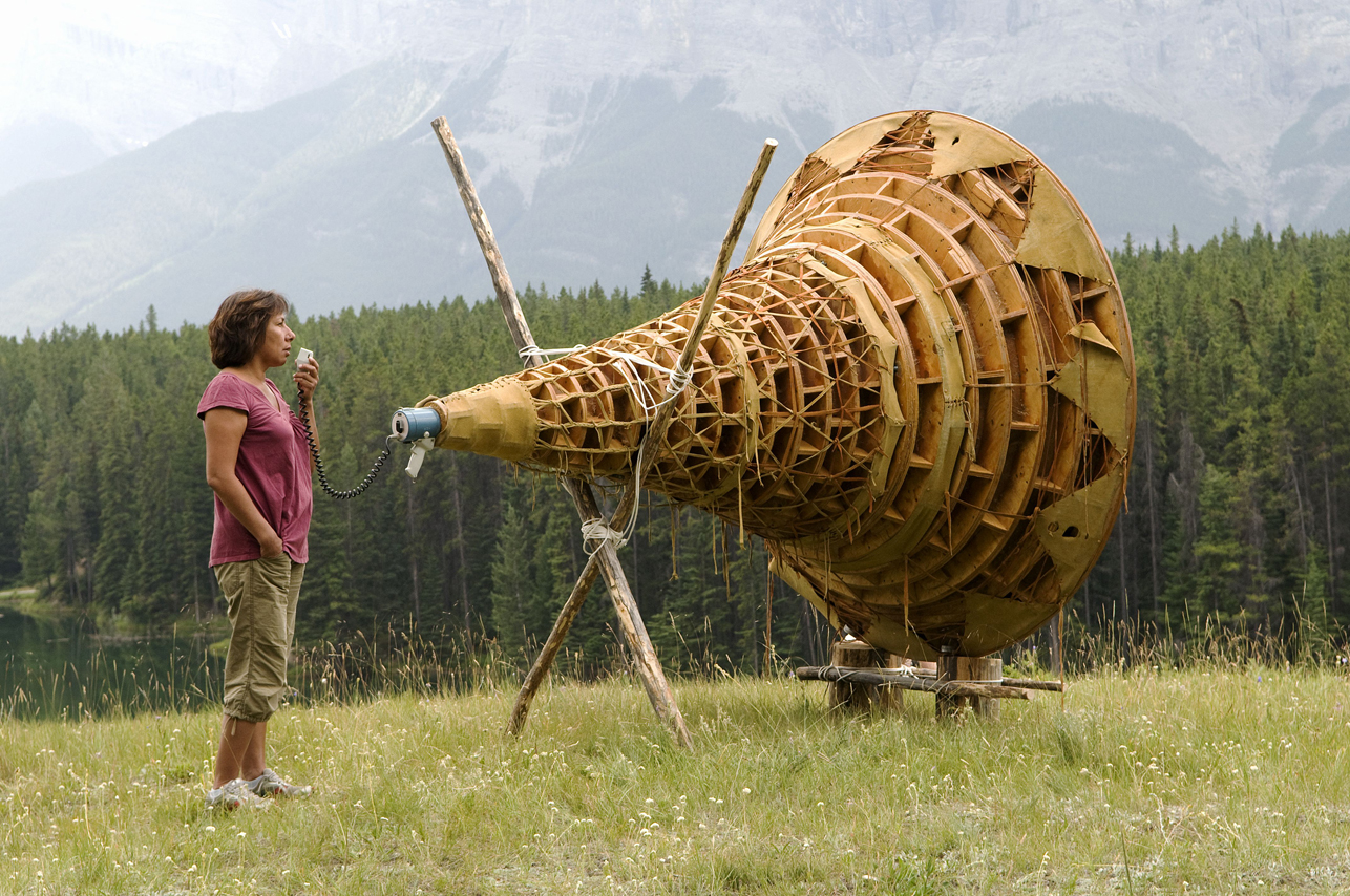 Rebecca Belmore activating her work Ayum - ee-aawach Oomama-mowan: Speaking to Their Mother , (1991) at Johnson Lake, Banff National Park, as part of the exhibition Bureau de Change , presented by the Walter Phillips Gallery, Alberta, Canada, 2008