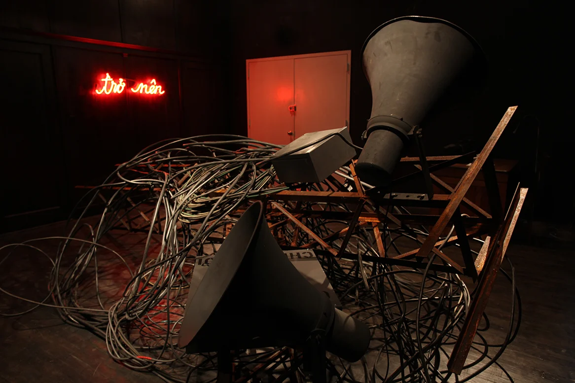 To Speak A Language (2012) Angle iron, electric wires, public address speakers, metal boxes, found book, neon light, amplifier, sound 168 “ x 120” x 24” Installation view at Agape Enterprise Courtesy the artist 