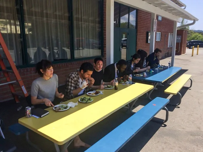 Actors and crew sit for a meal at the theater in Topanga, CA.