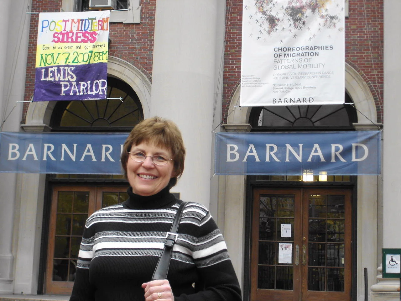 Cathy in front of school.jpg