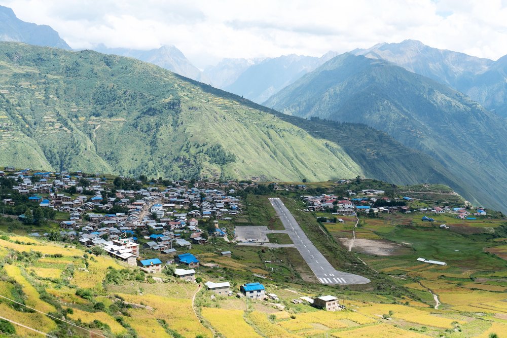 The town of Simikot and its airport perched on a flat area on a mountain. Every time a cloud passes no planes can land or takeoff.