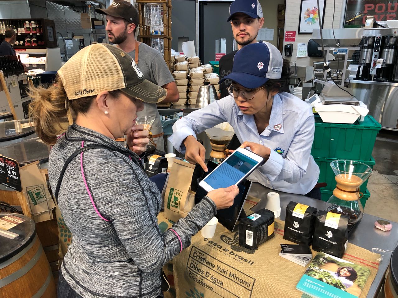 Reading the QR code that shows the coffee traceability up to the producer and farm level to a customer at Central Market