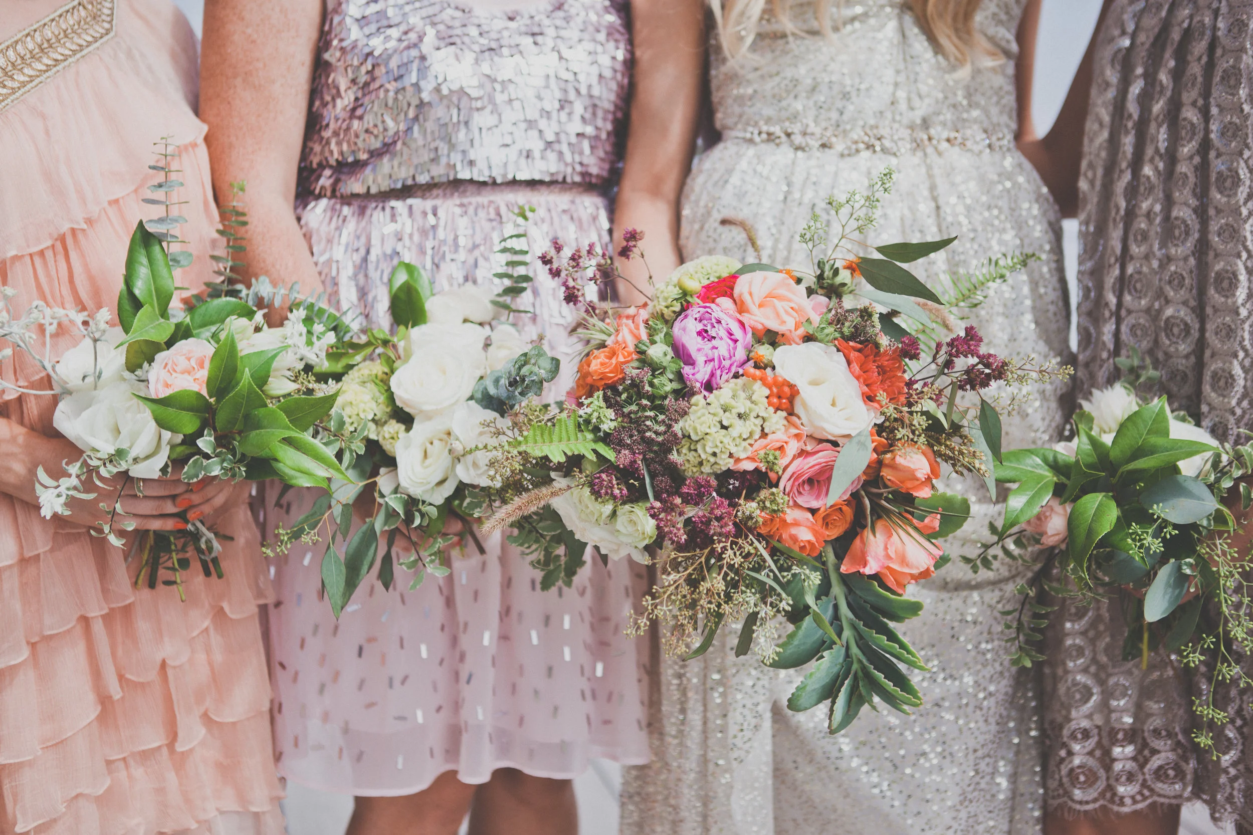 Assorted sequin dresses + blooms by Big Sur Flowers