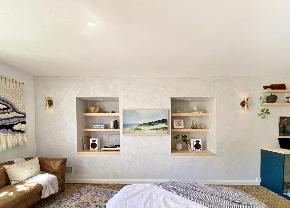  The two-tone Roman clay plastered walls create added dimension to the niches and continue into the kitchen to serve as a backsplash.  