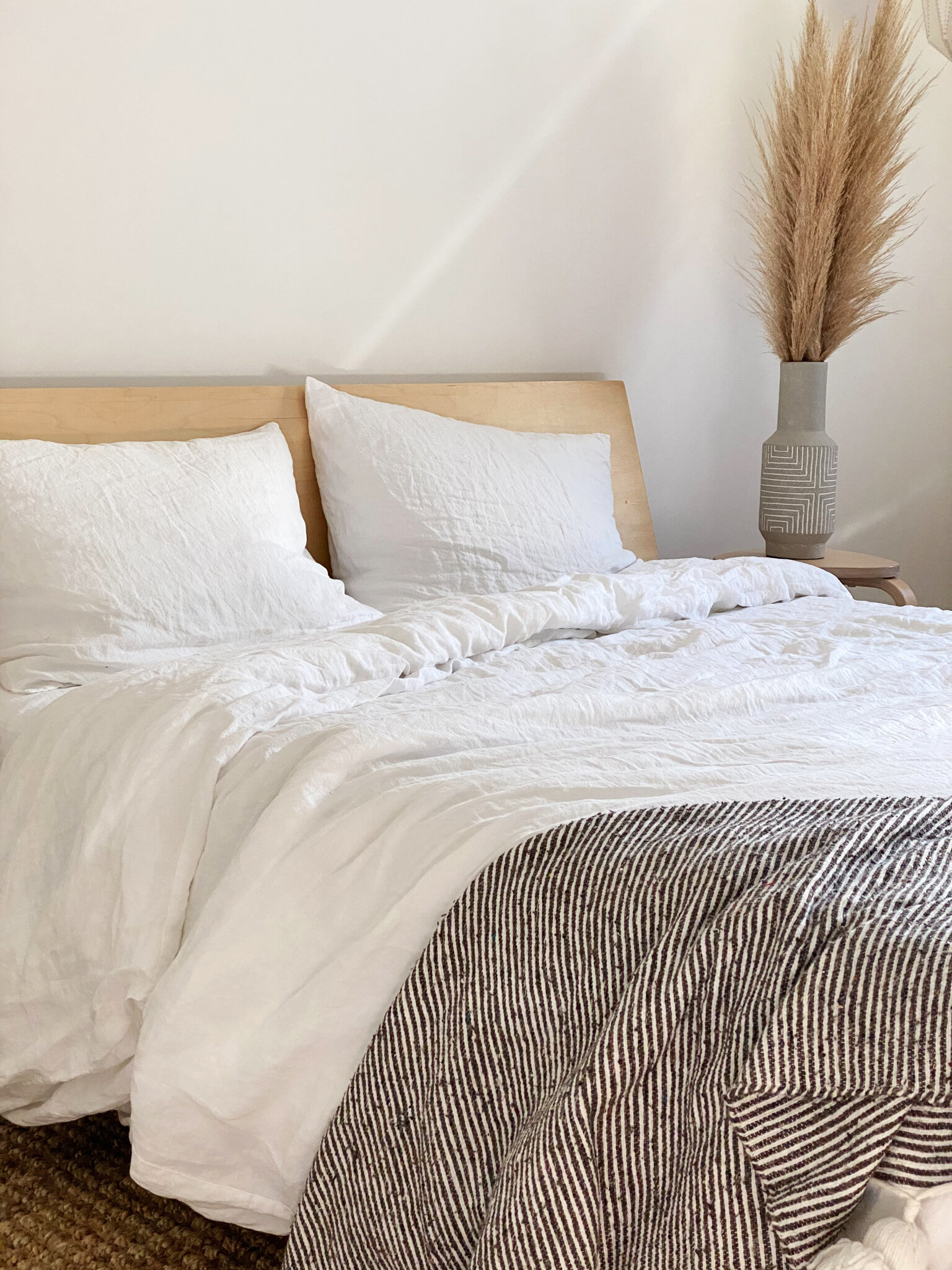  We kept the bed light and neutral with Parachute linen bedding and a simple Moroccan throw. 