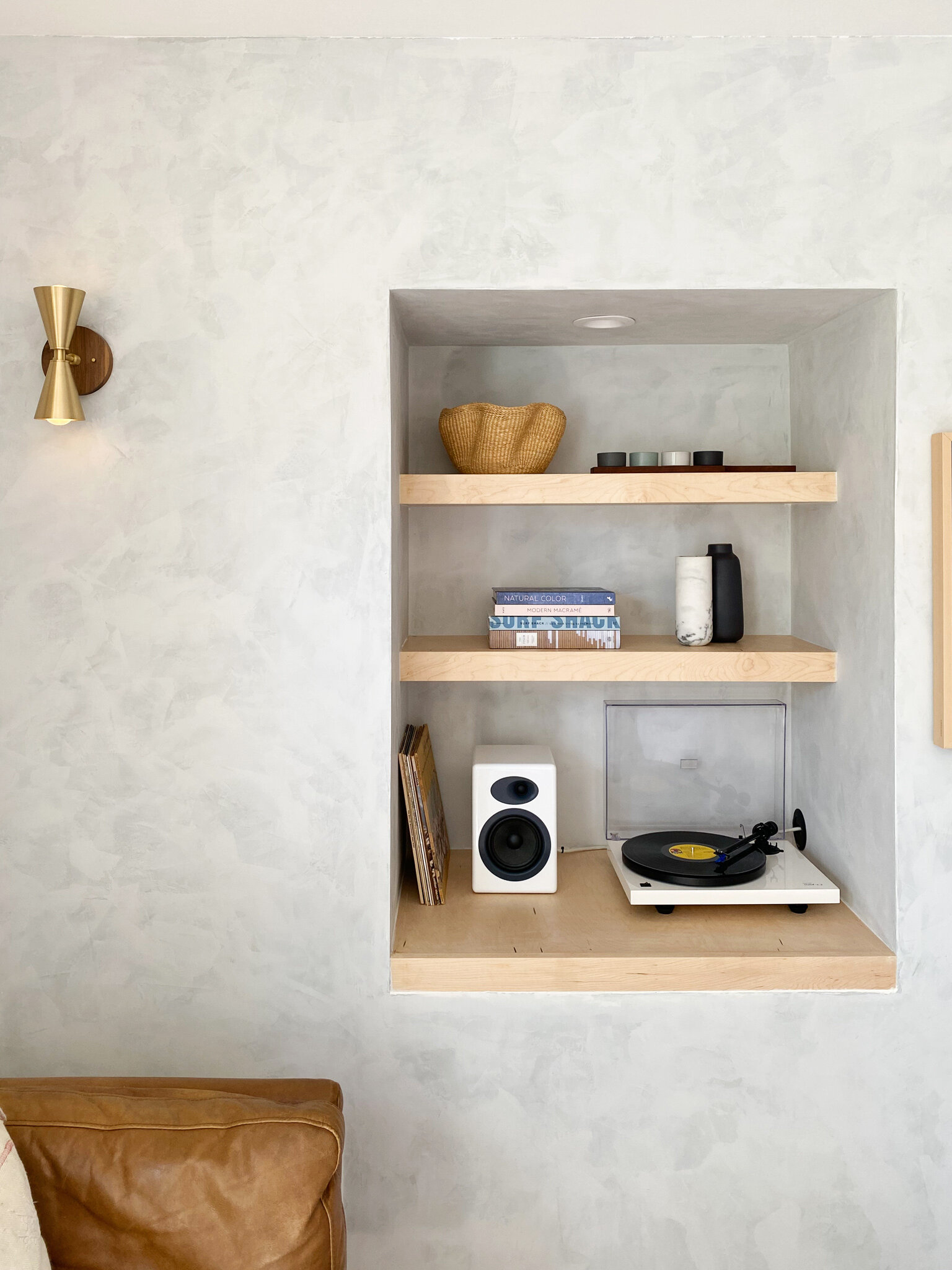  The floating shelves and bench seats were constructed from the same maple pine as the bed and office to create a cohesive feel in such a small space. 