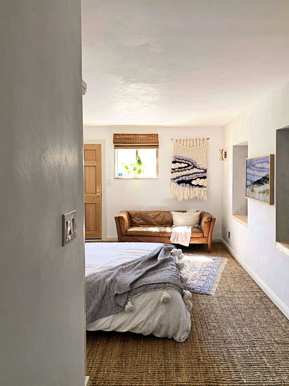  View from the kitchen/office into the living/sleeping space. White limewash adds texture to the walls and ceiling.  