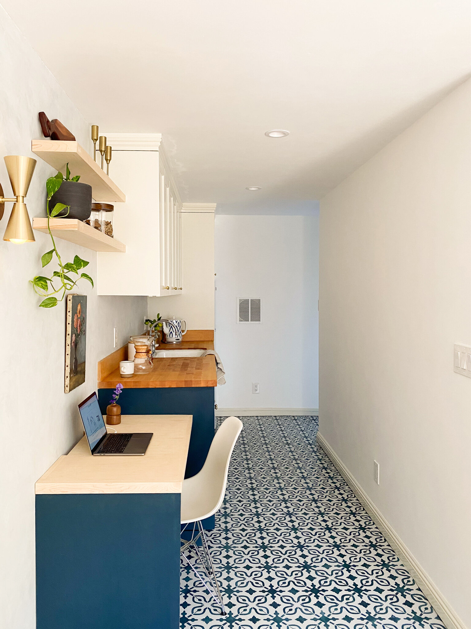  The patterned floor extends the length of the kitchen, around the corner to the entryway and into the bathroom. 