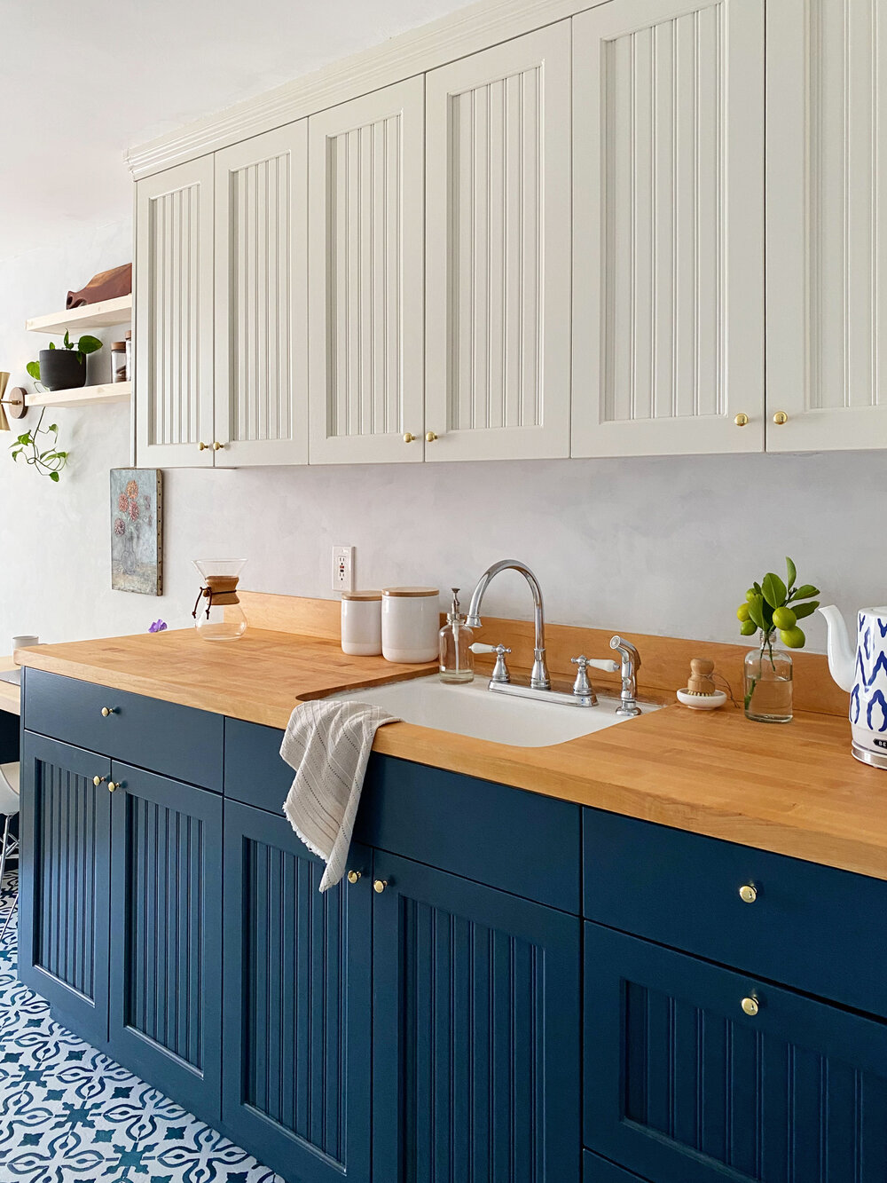  Painting the upper cabinets white kept them from feeling too heavy and visually opened up the space.  