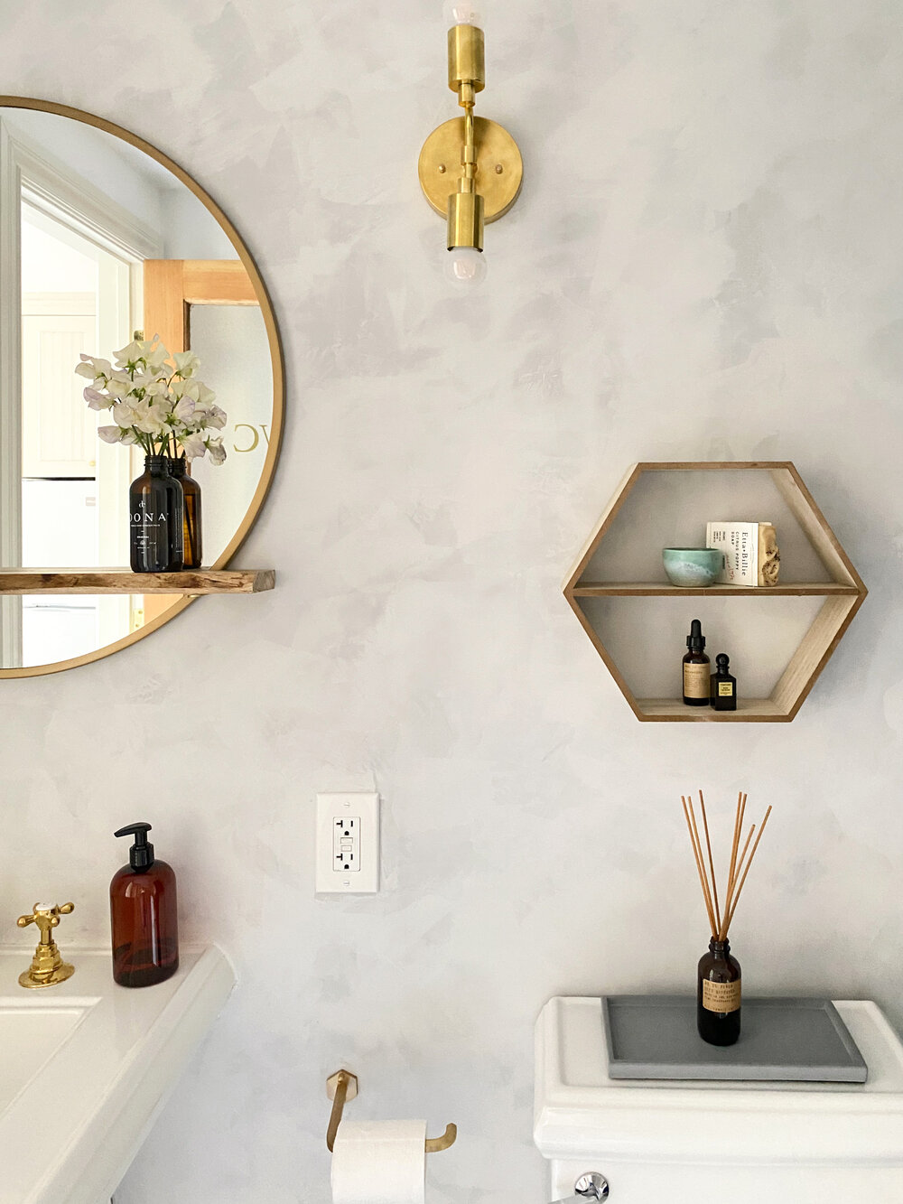  The bathroom wall is done in the same Roman Clay finish as the living space to create a focal point. 