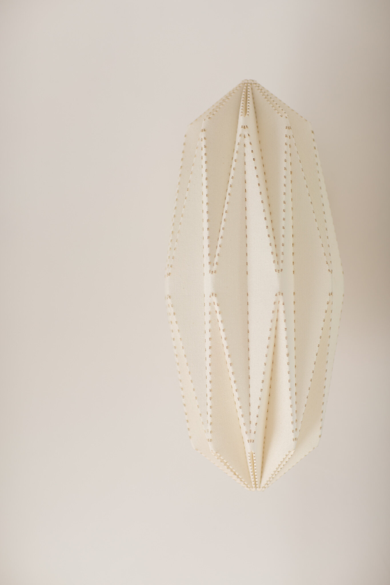  This pleated linen shade has a soothing glow and is made in CA by California Workshop for Room and Board. 