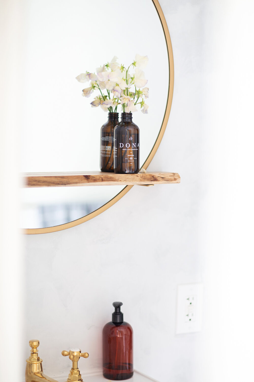  A repurposed bottle stands in for a vase. 