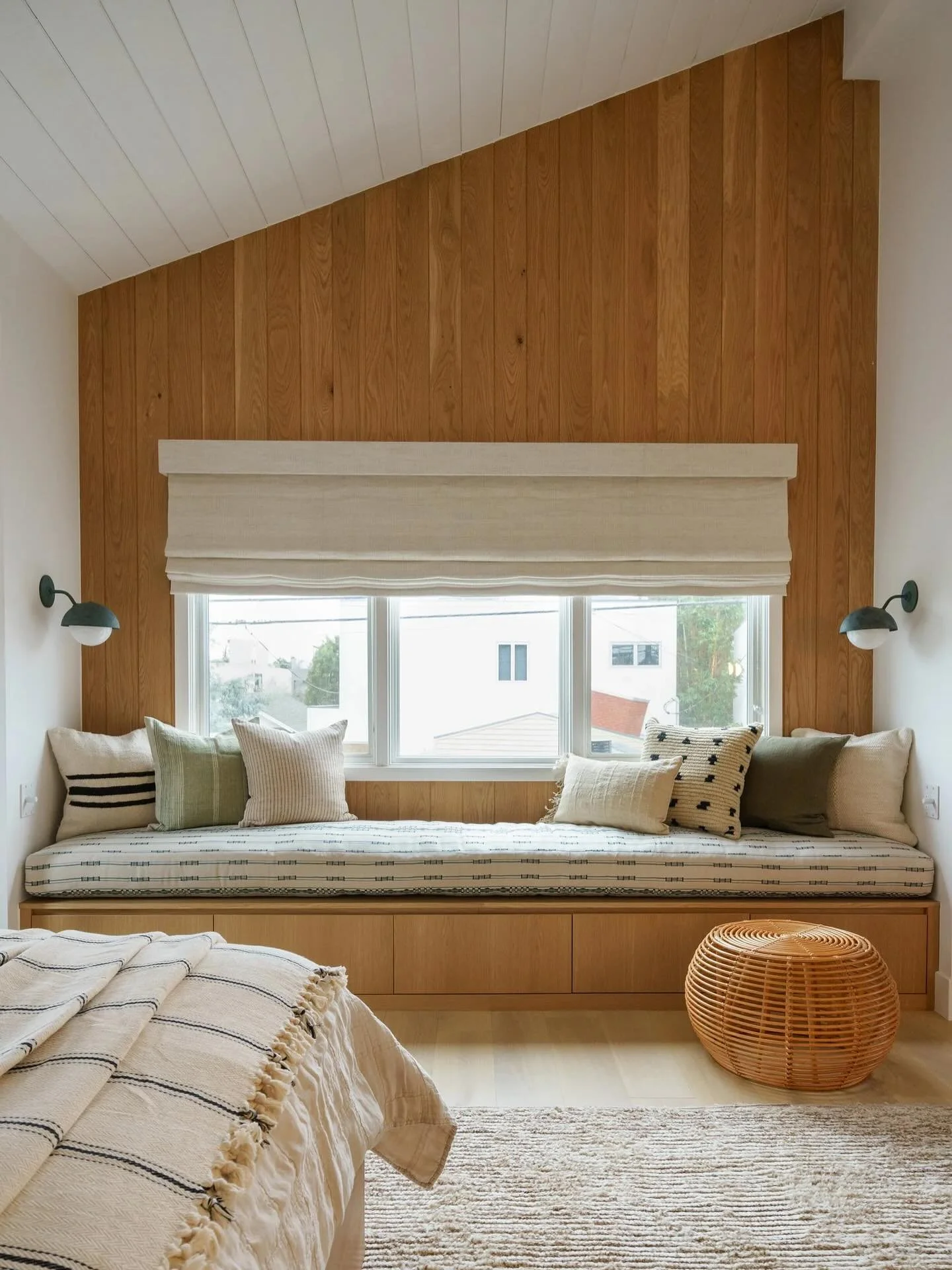 the primary bed builtin bench nook meant to feel like a big warm hug 🧸 white oak tongue &amp; groove, a mix of textures and patterns through textiles, and a verdigris finish on the sconces made for one dreamy moment to draw you right in as you enter
