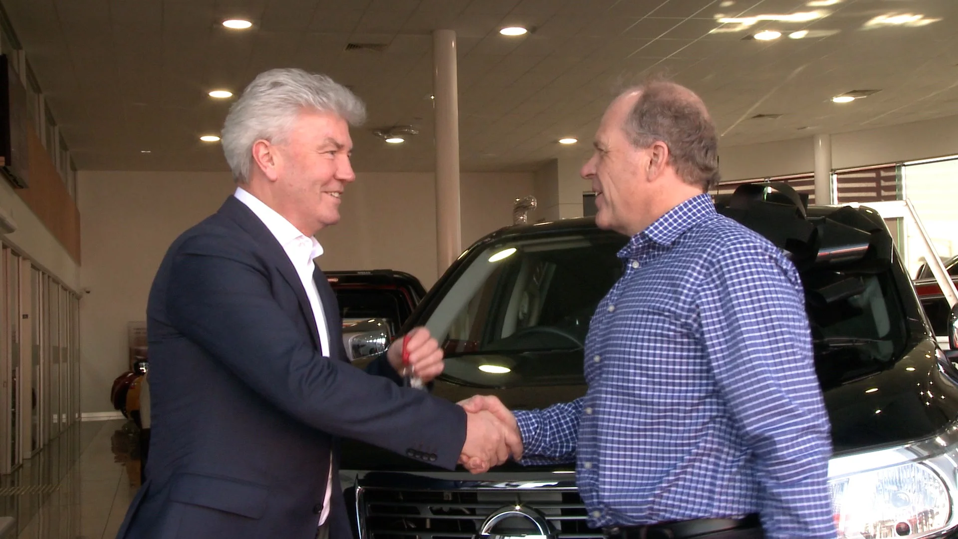Conrad Taylor presenting Michael Smith with the keys for their new Nissan Navara.