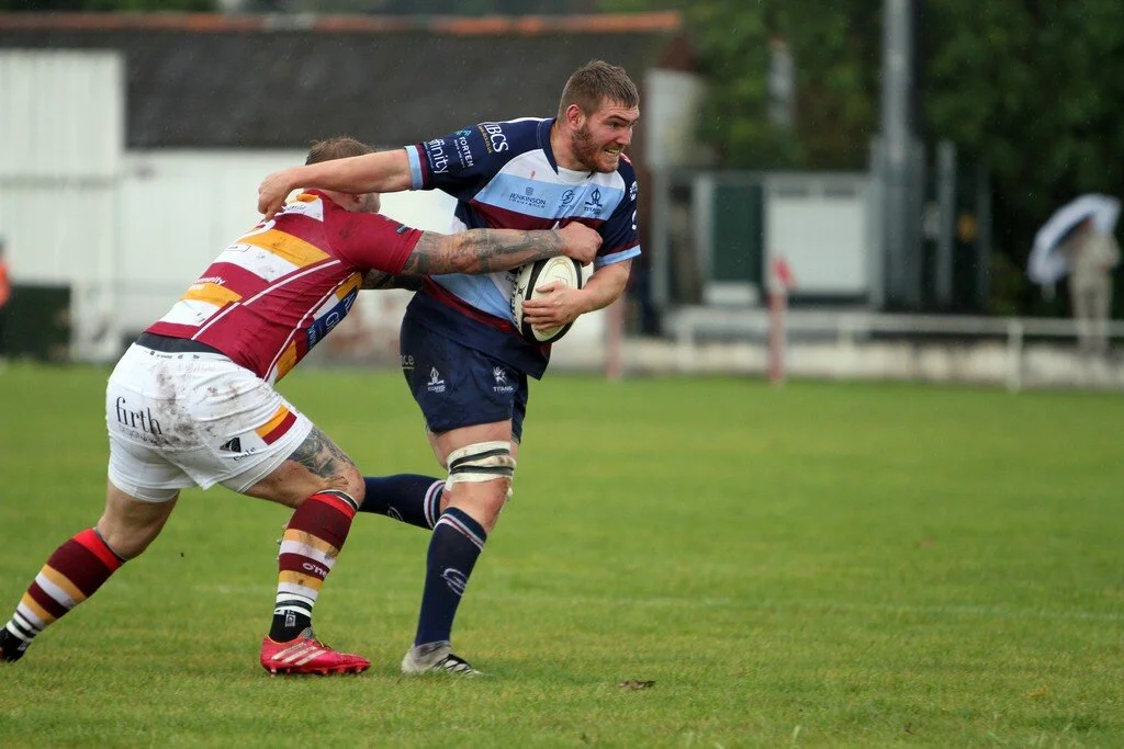 Zak Poole Tries To Hand Off Scott Rawlings.jpg