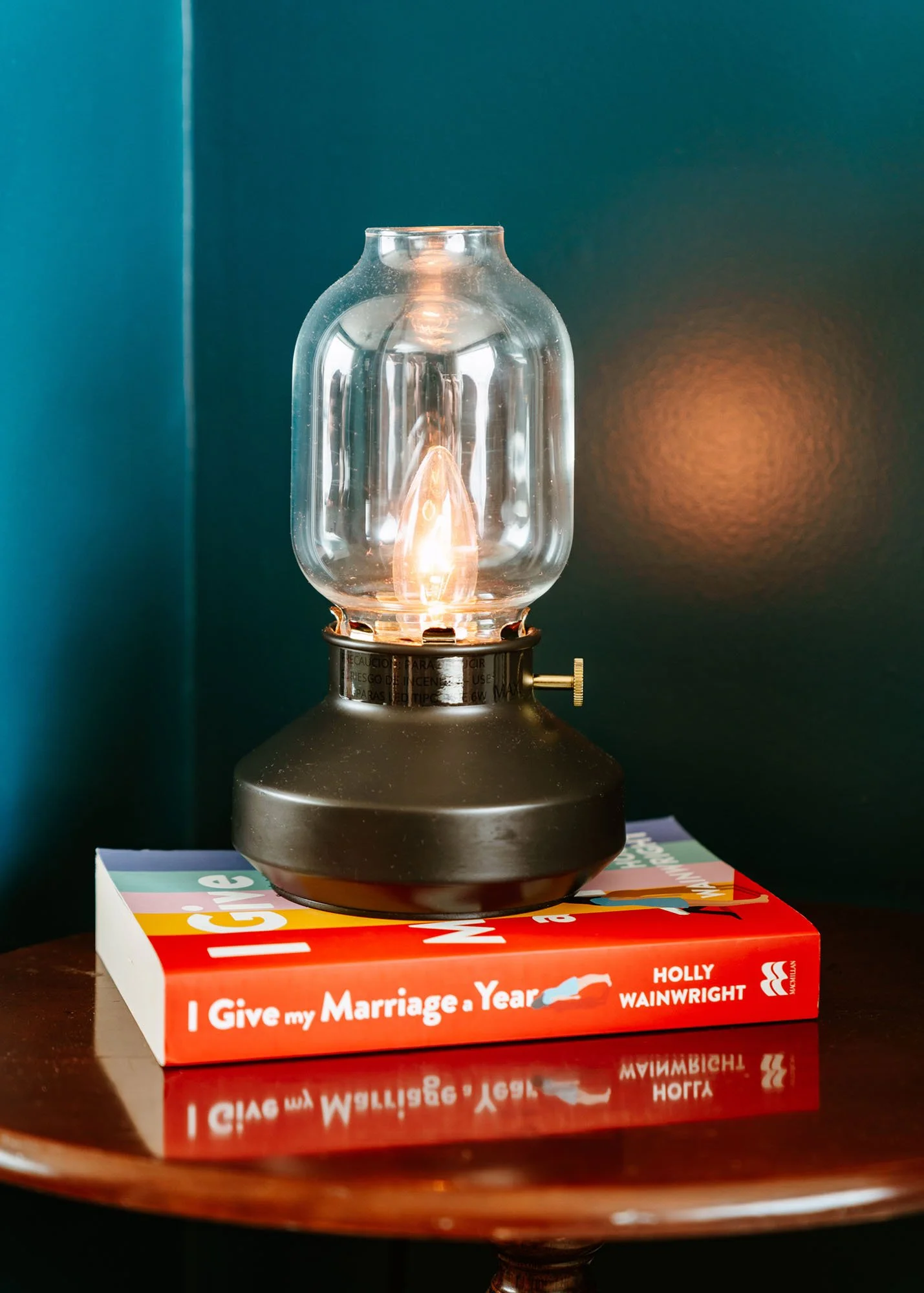 Interior photography by Worker Bee Supply showing a vintage ligth and books on a side table..