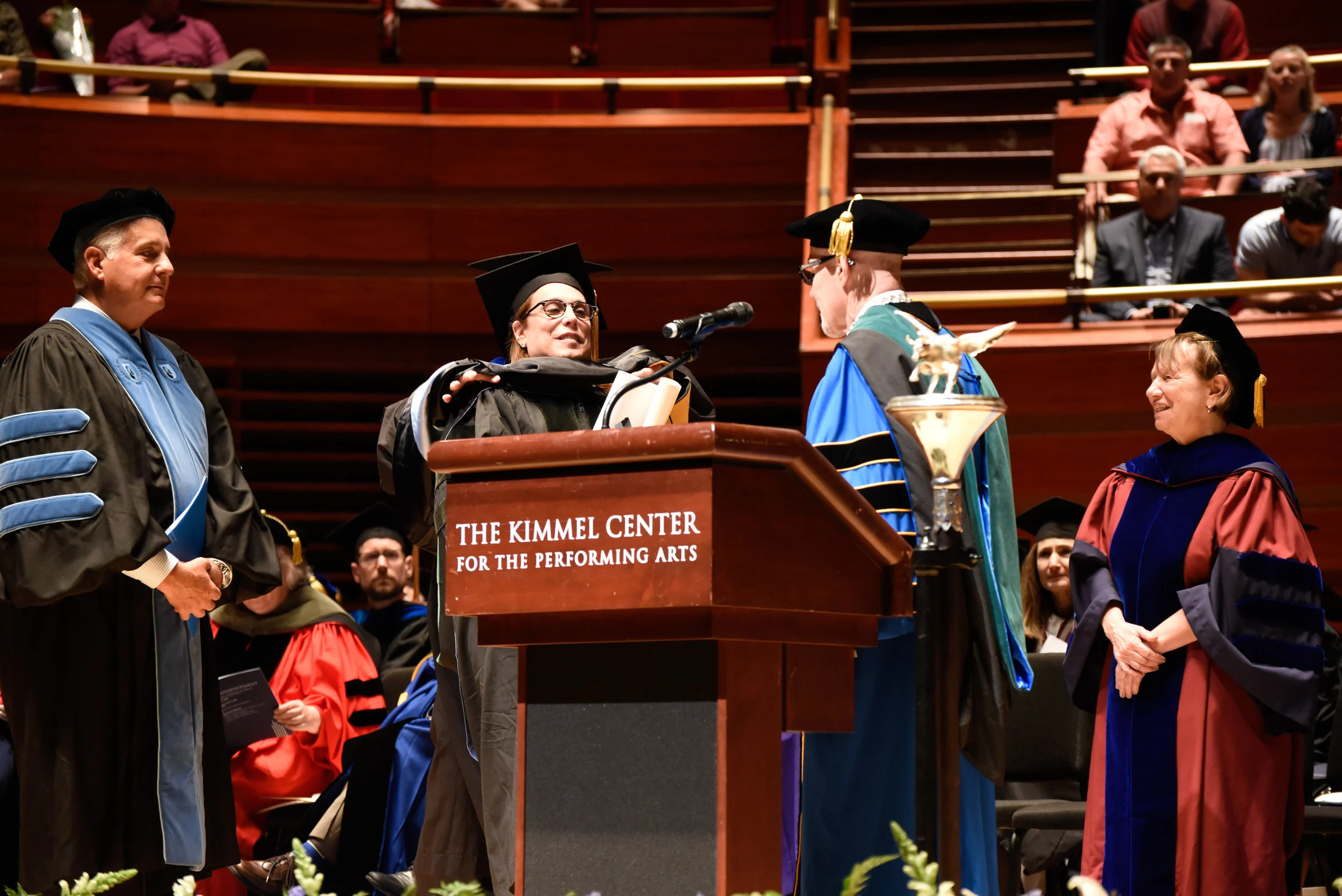 Academic ceremony image from the existing site