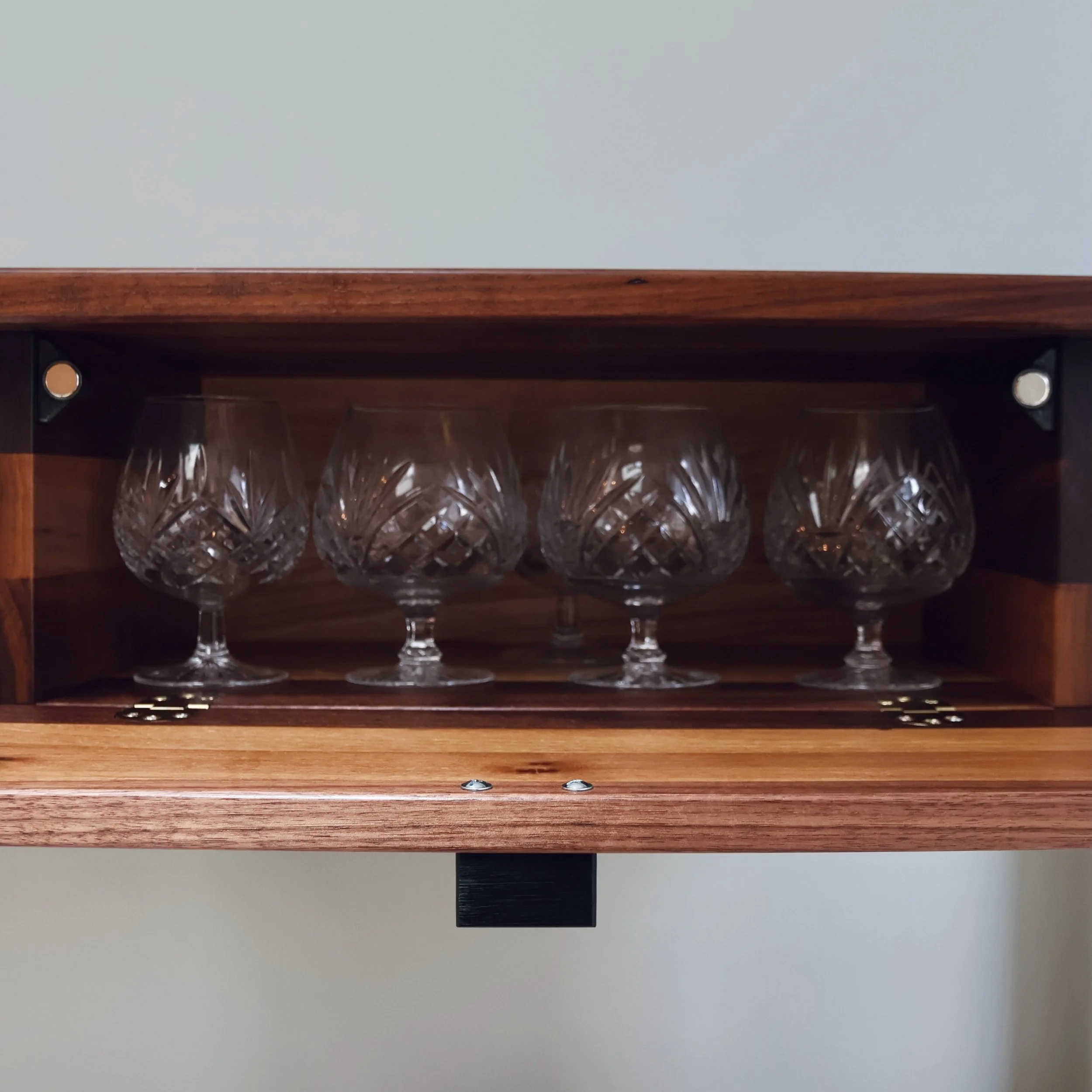 Bespoke walnut and maple console table with a place to store fine glassware