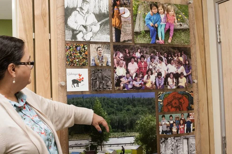 Lisa shows us the photo panel one sees next to the front desk of the Sutton clinic, welcoming community members and showing them that they are welcome here.