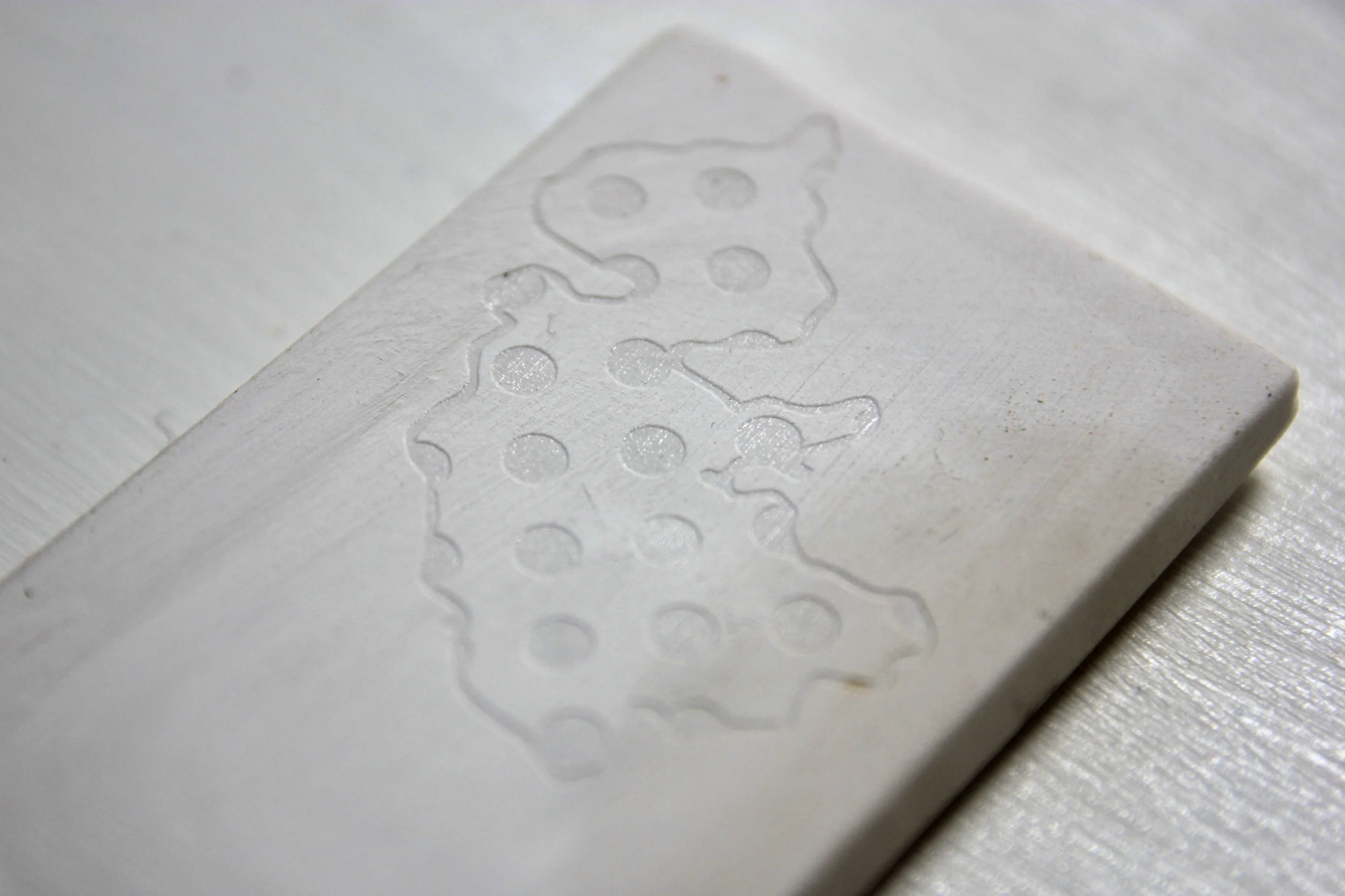 Laser etching onto kiln-fired ceramic